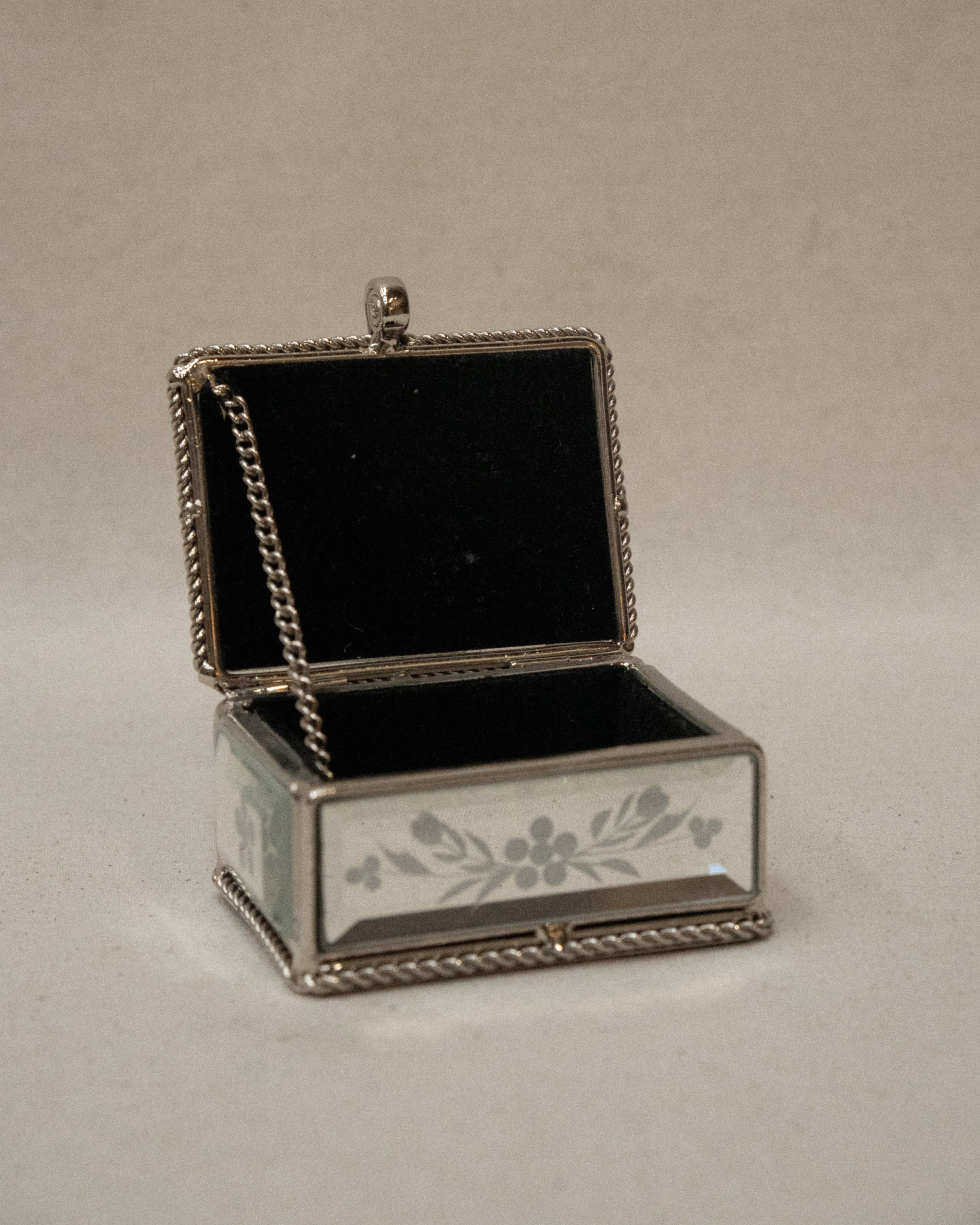 Mirrorred trinket box with etchings, rope edges, scroll handle and lined with fabric