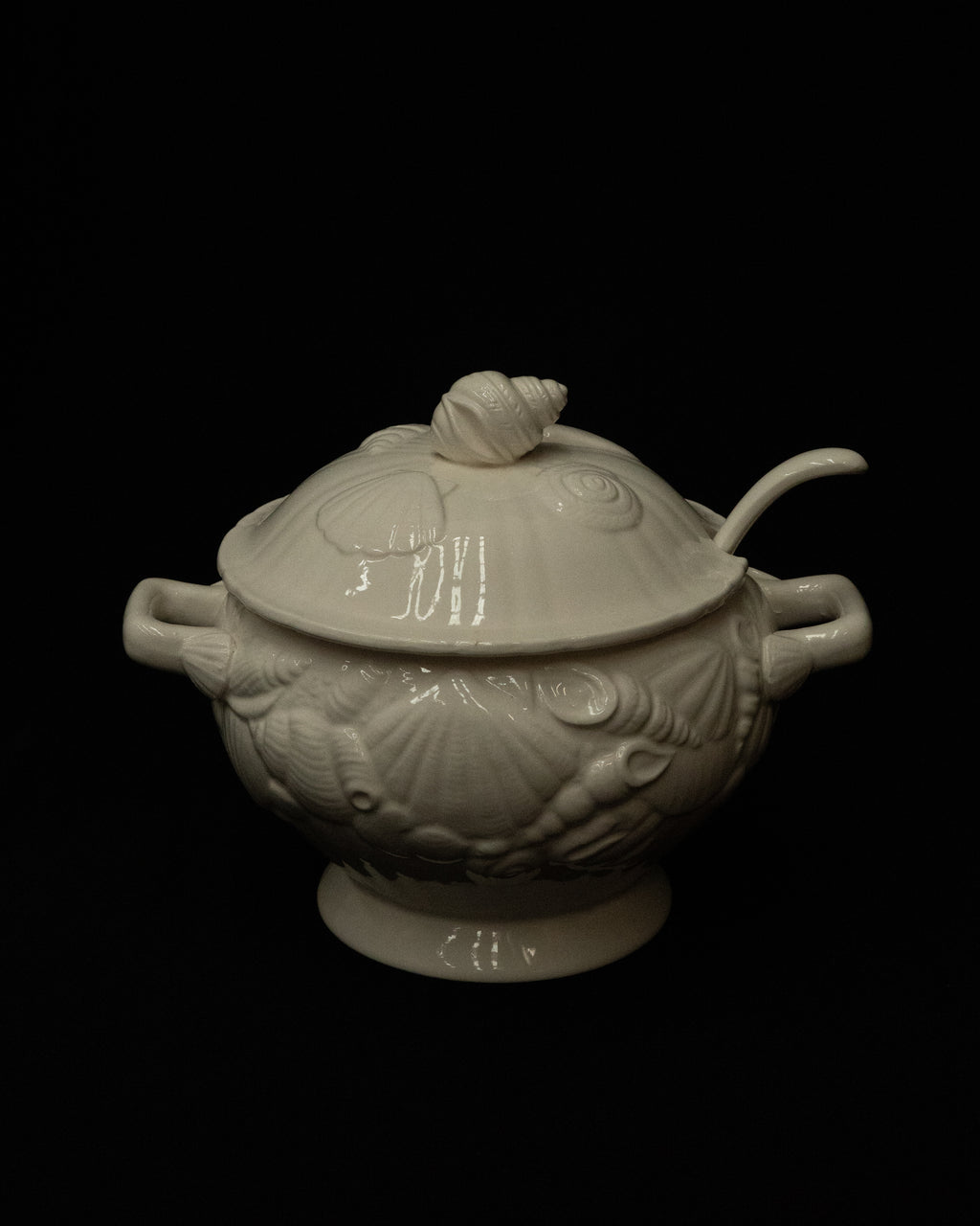 White ceramic punch bowl adorned with shells