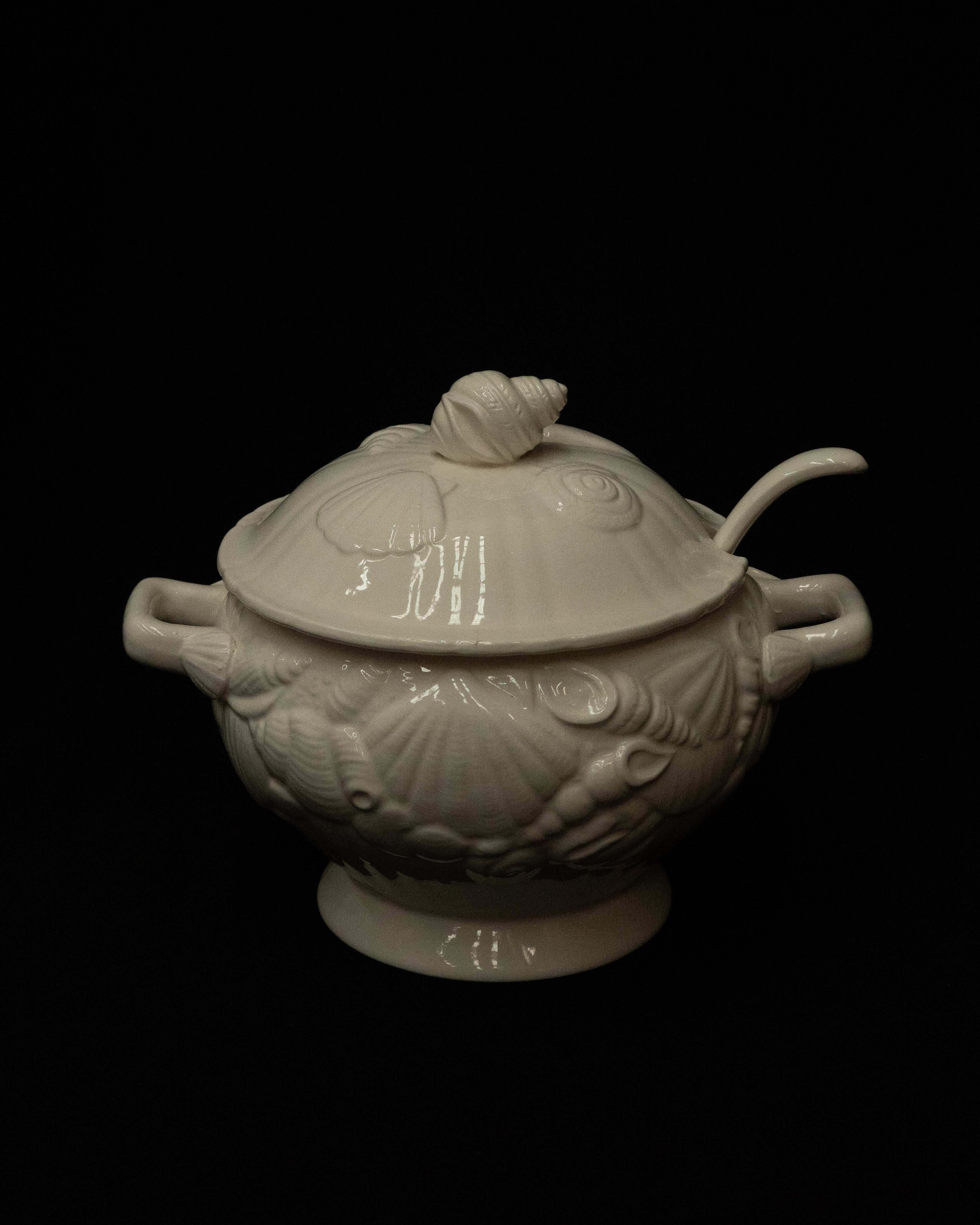 White ceramic punch bowl adorned with shells