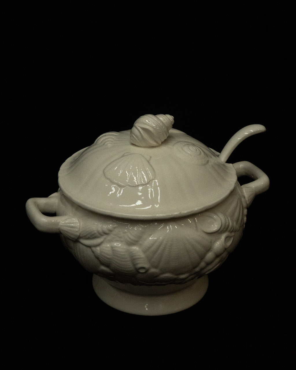 White ceramic punch bowl adorned with shells