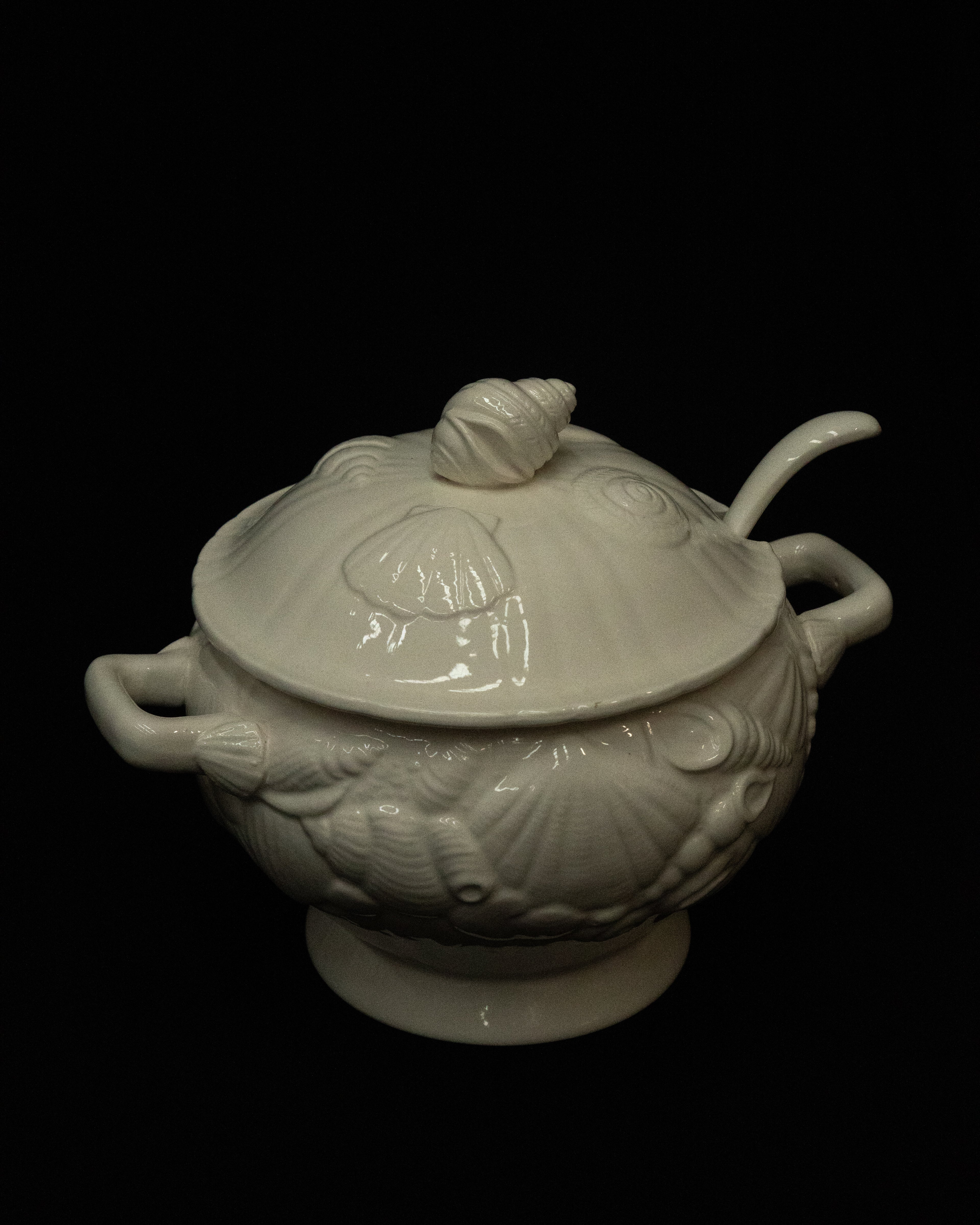 White ceramic punch bowl adorned with shells