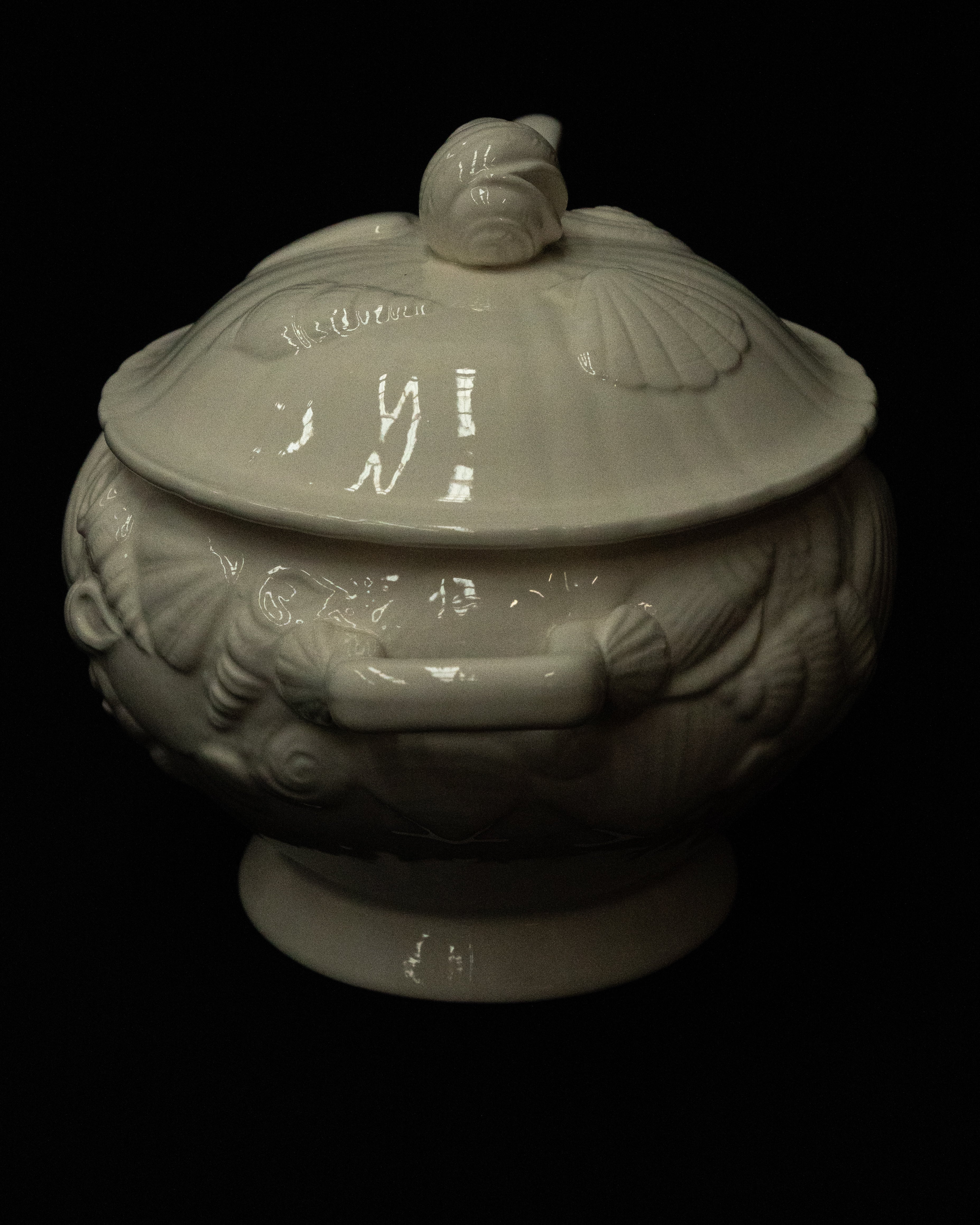 White ceramic punch bowl adorned with shells