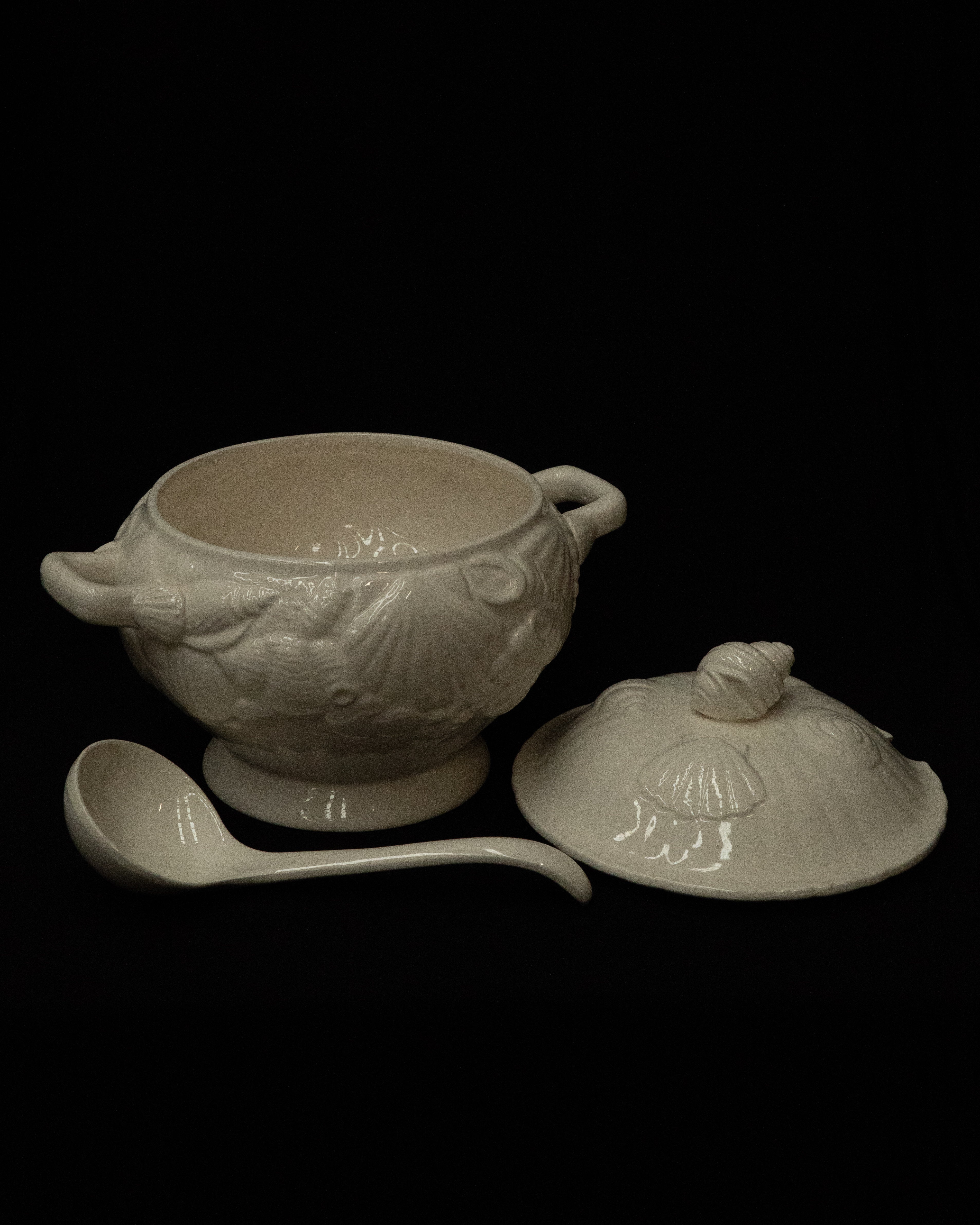 White ceramic punch bowl adorned with shells