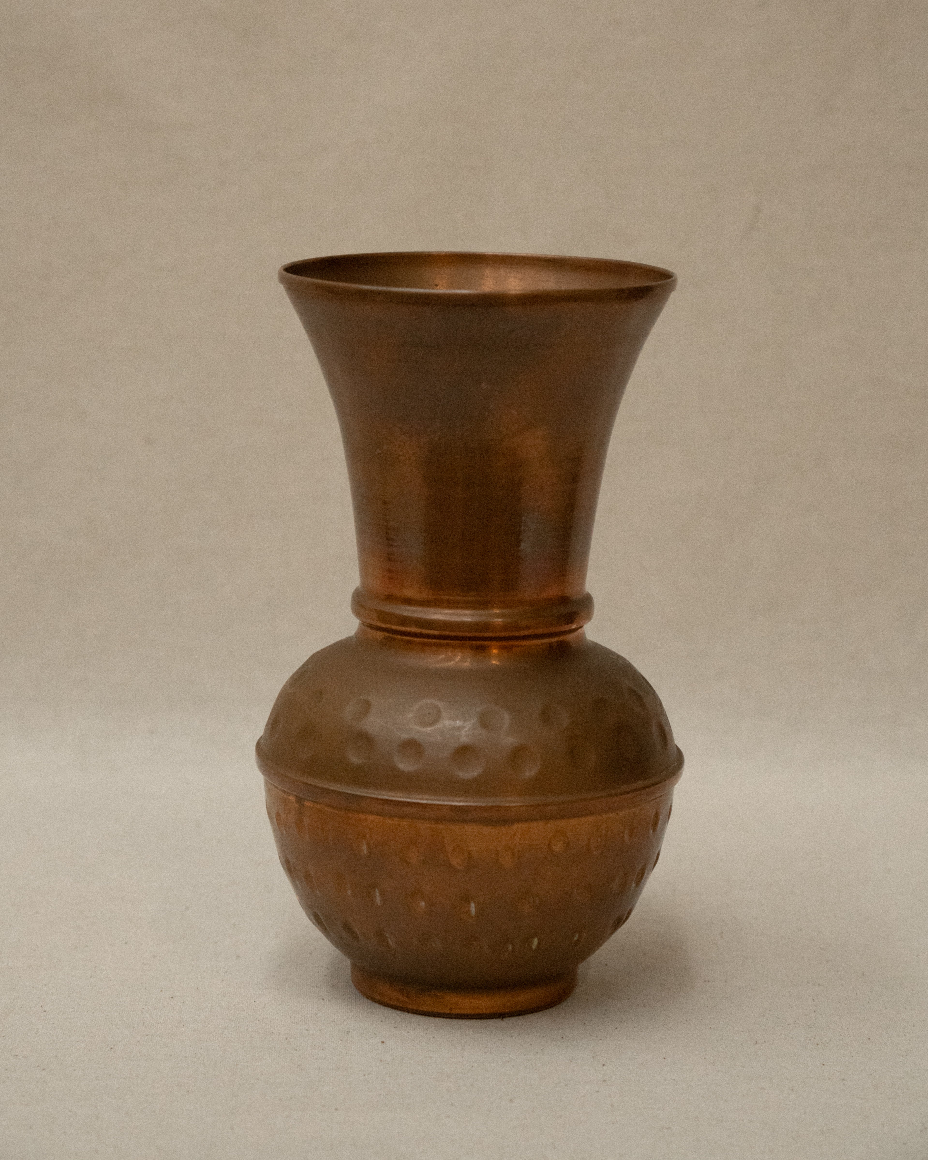 Hammered copper tapered vase with rounded base