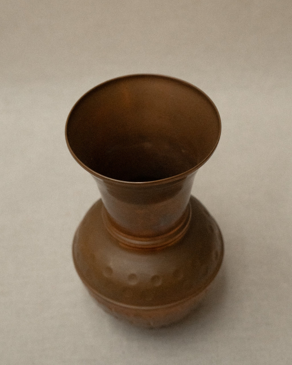 Hammered copper tapered vase with rounded base