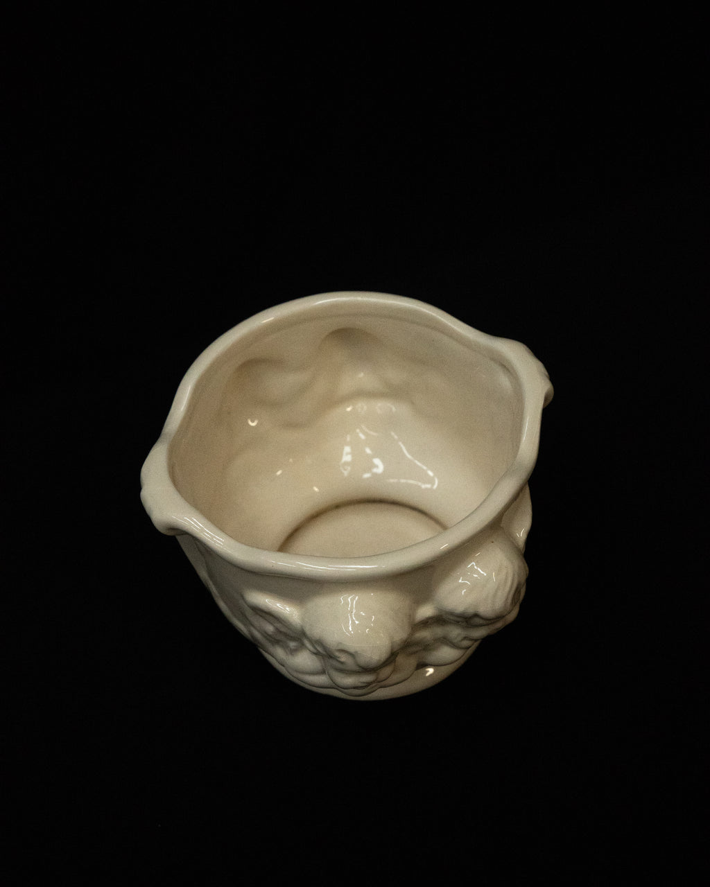 White ceramic pot featuring two pairs of cherubs