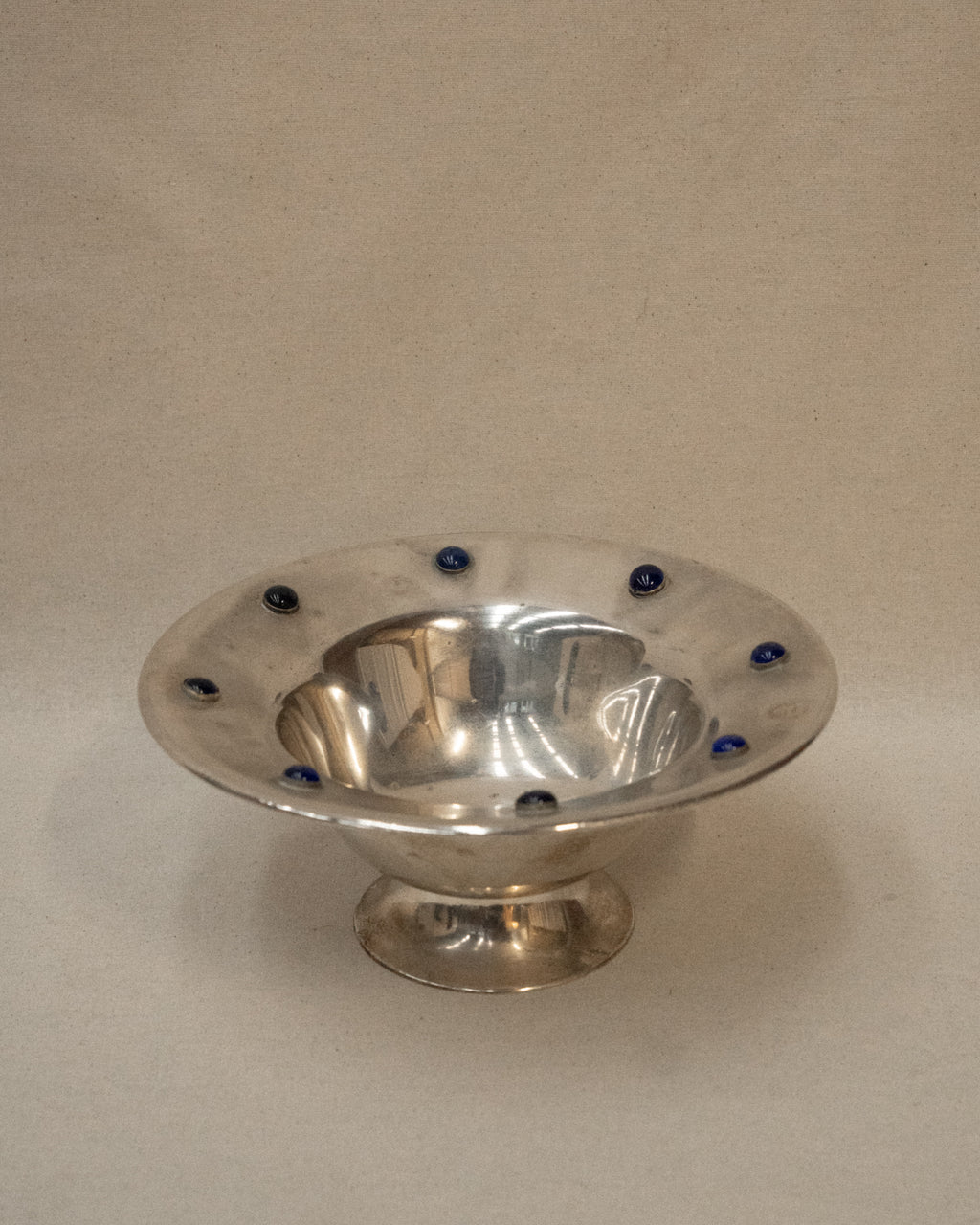 Silver plated bowl adorned with blue stones