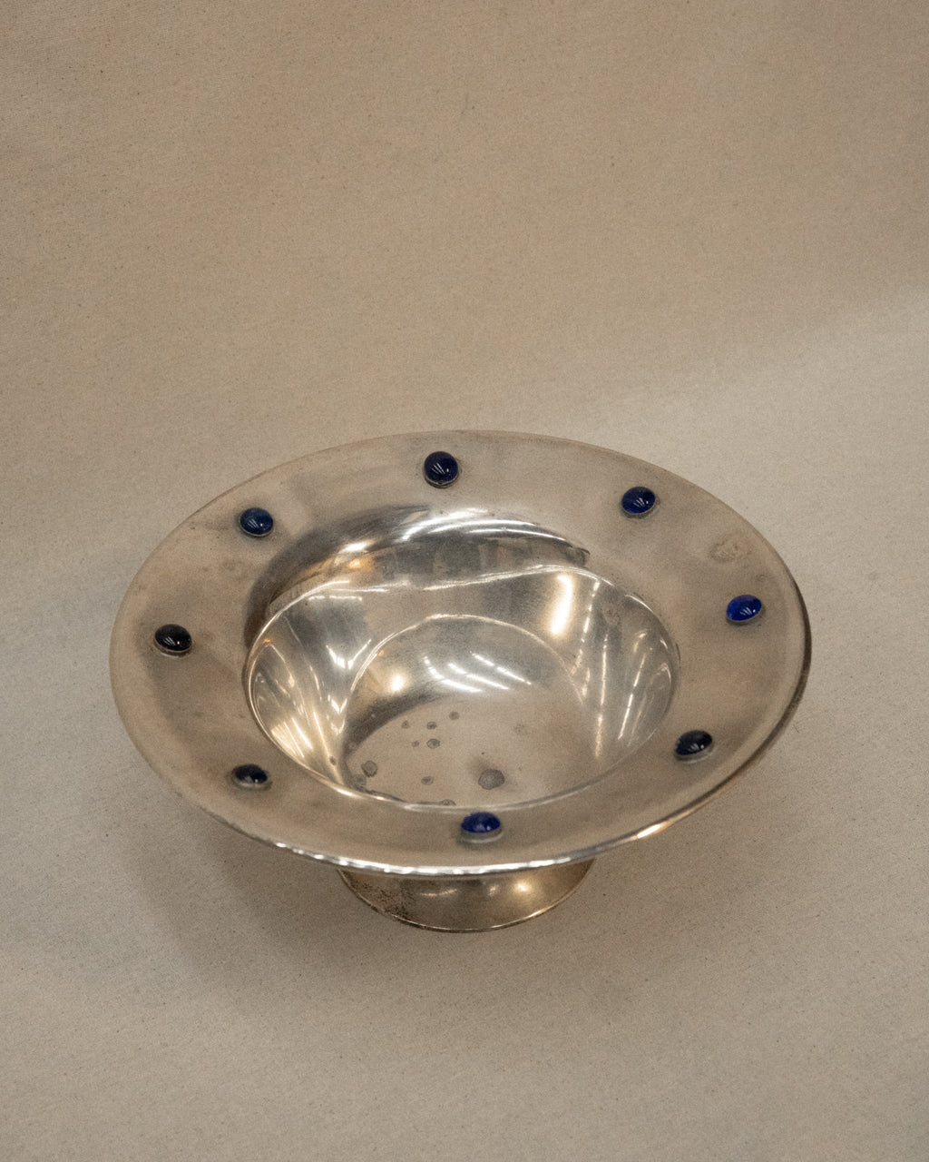 Silver plated bowl adorned with blue stones