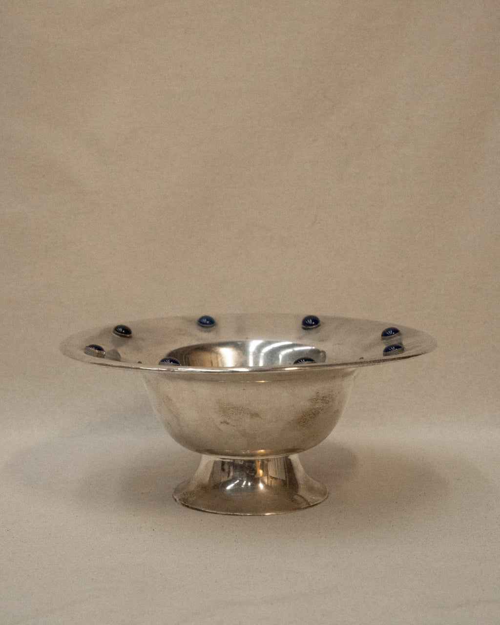 Silver plated bowl adorned with blue stones