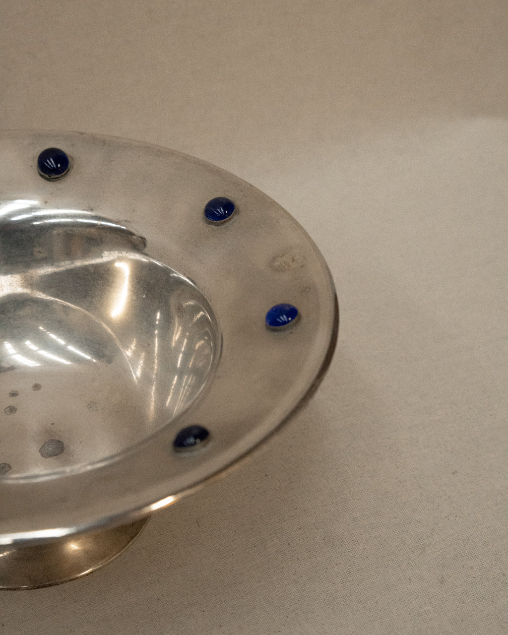 Silver plated bowl adorned with blue stones