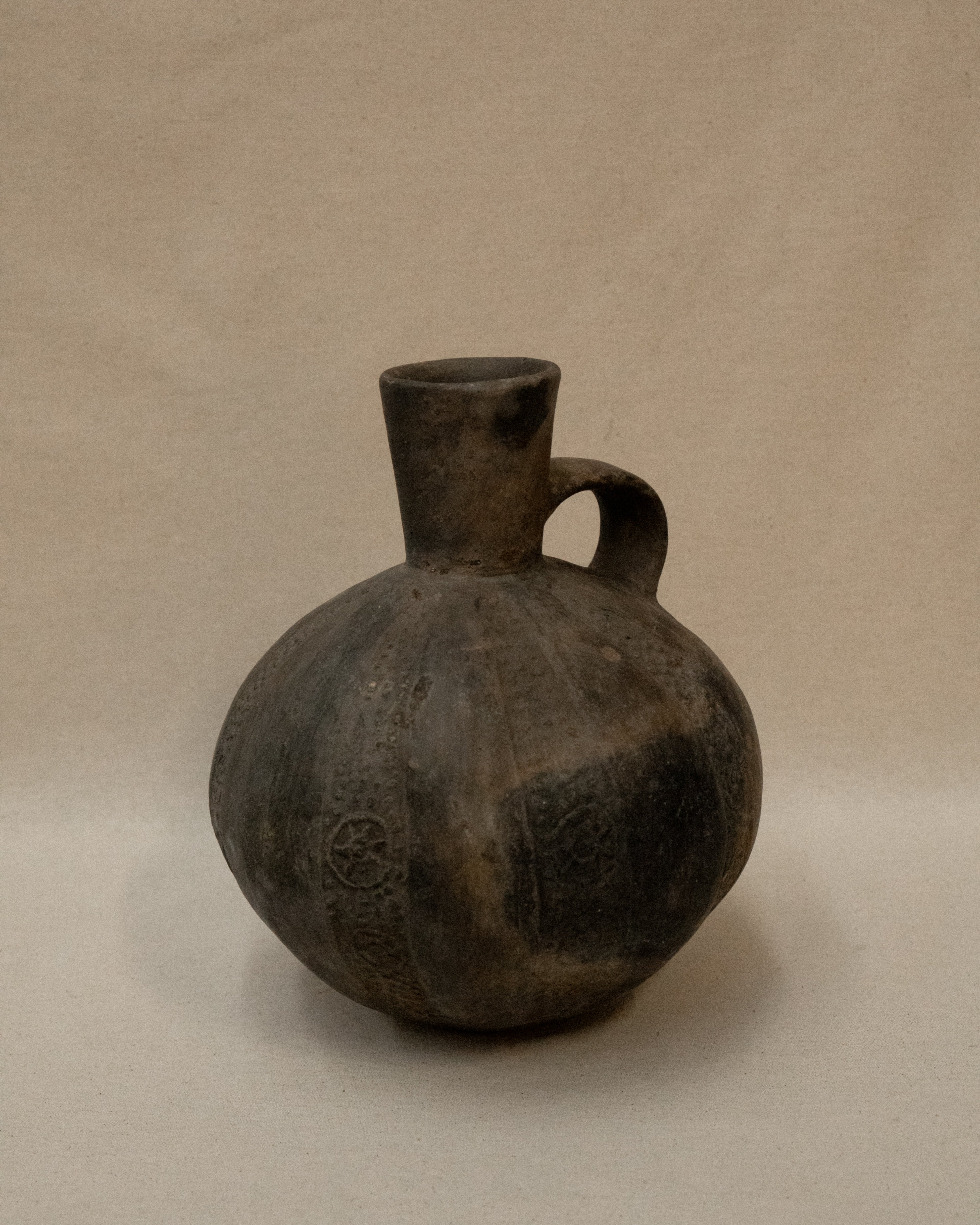A Pre-Columbian Chimu blackware gourd shaped vessel with handle at the neck