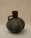 A Pre-Columbian Chimu blackware gourd shaped vessel with handle at the neck