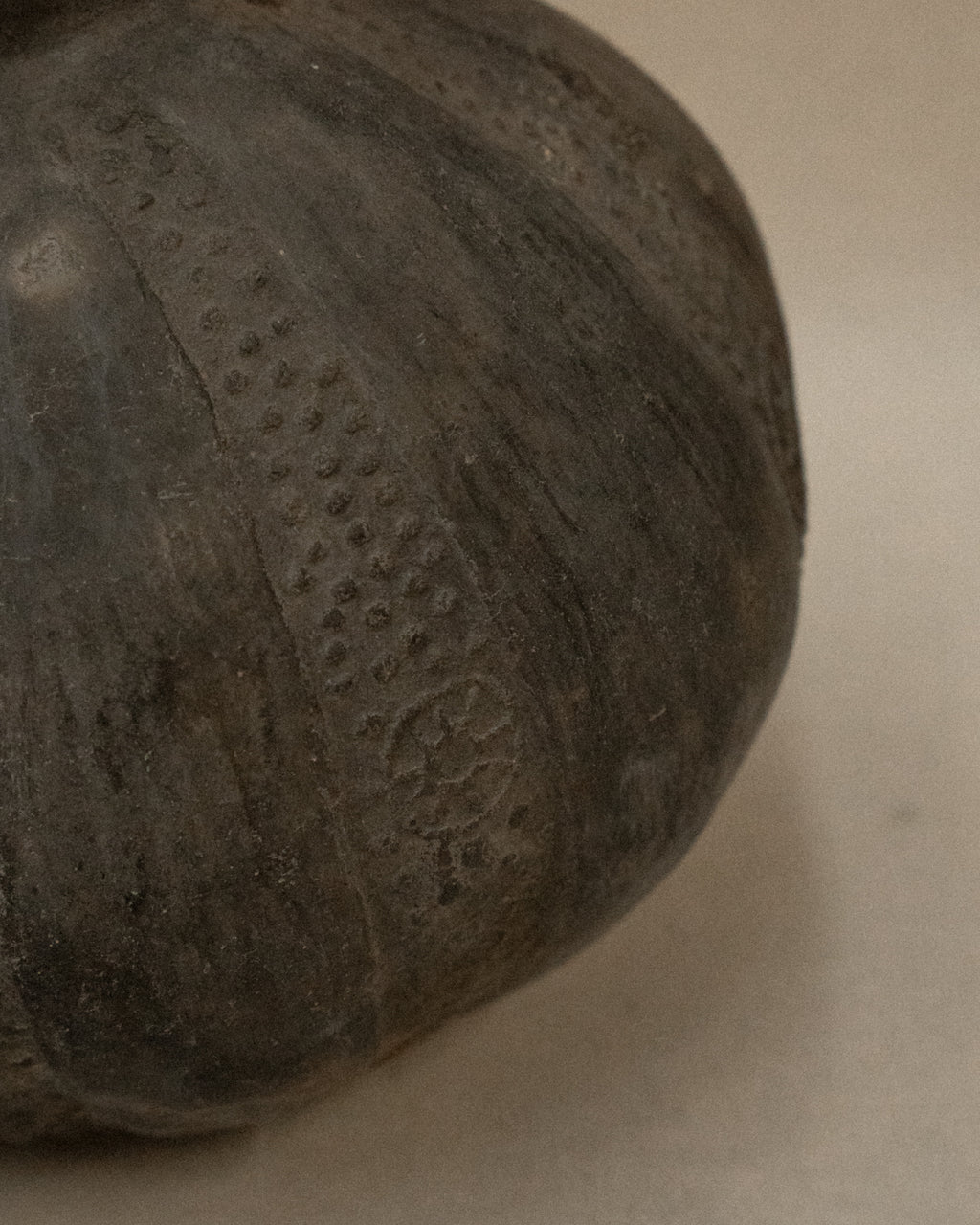 A Pre-Columbian Chimu blackware gourd shaped vessel with handle at the neck