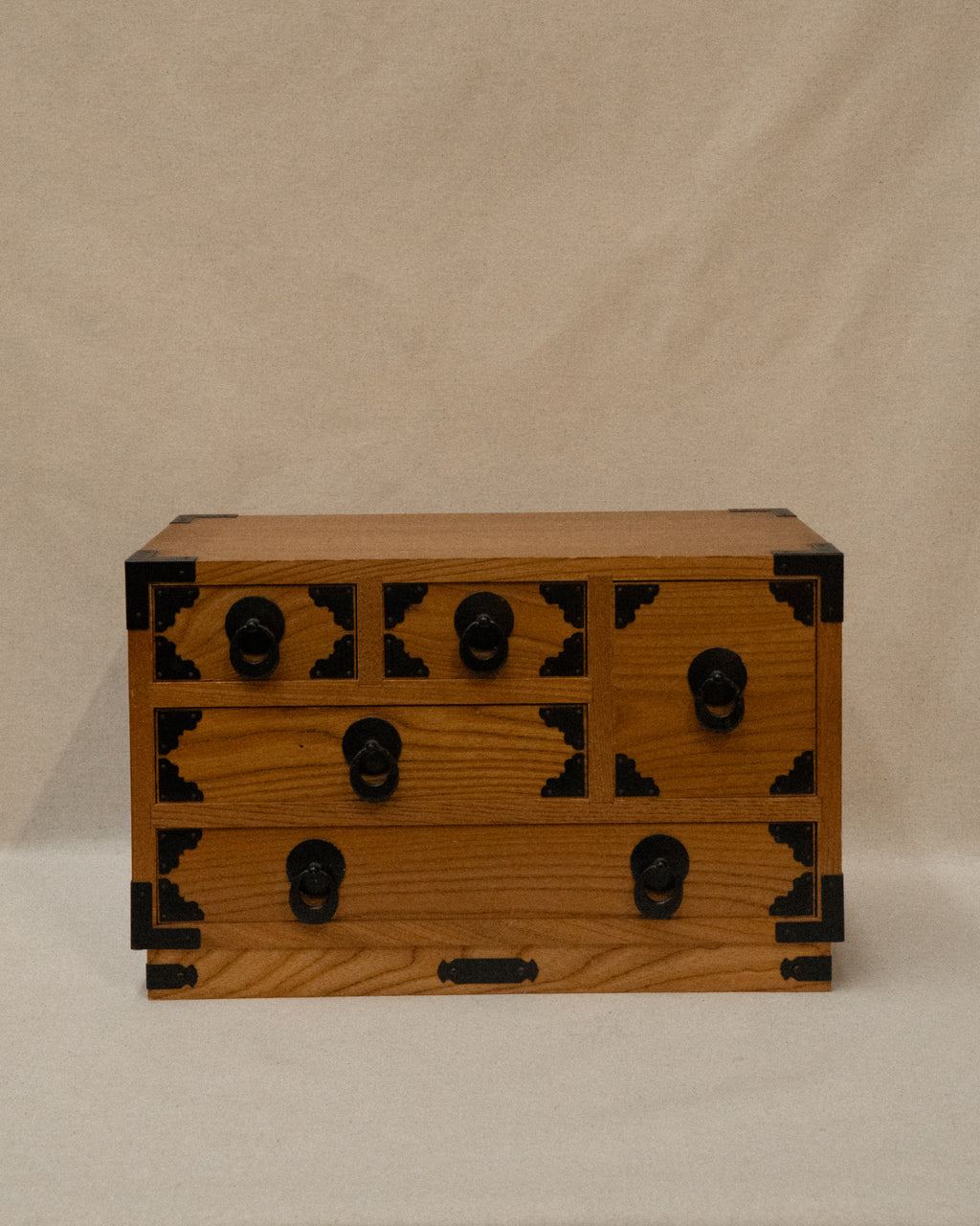 Japanese wooden chest of drawers lined with yellow fabric