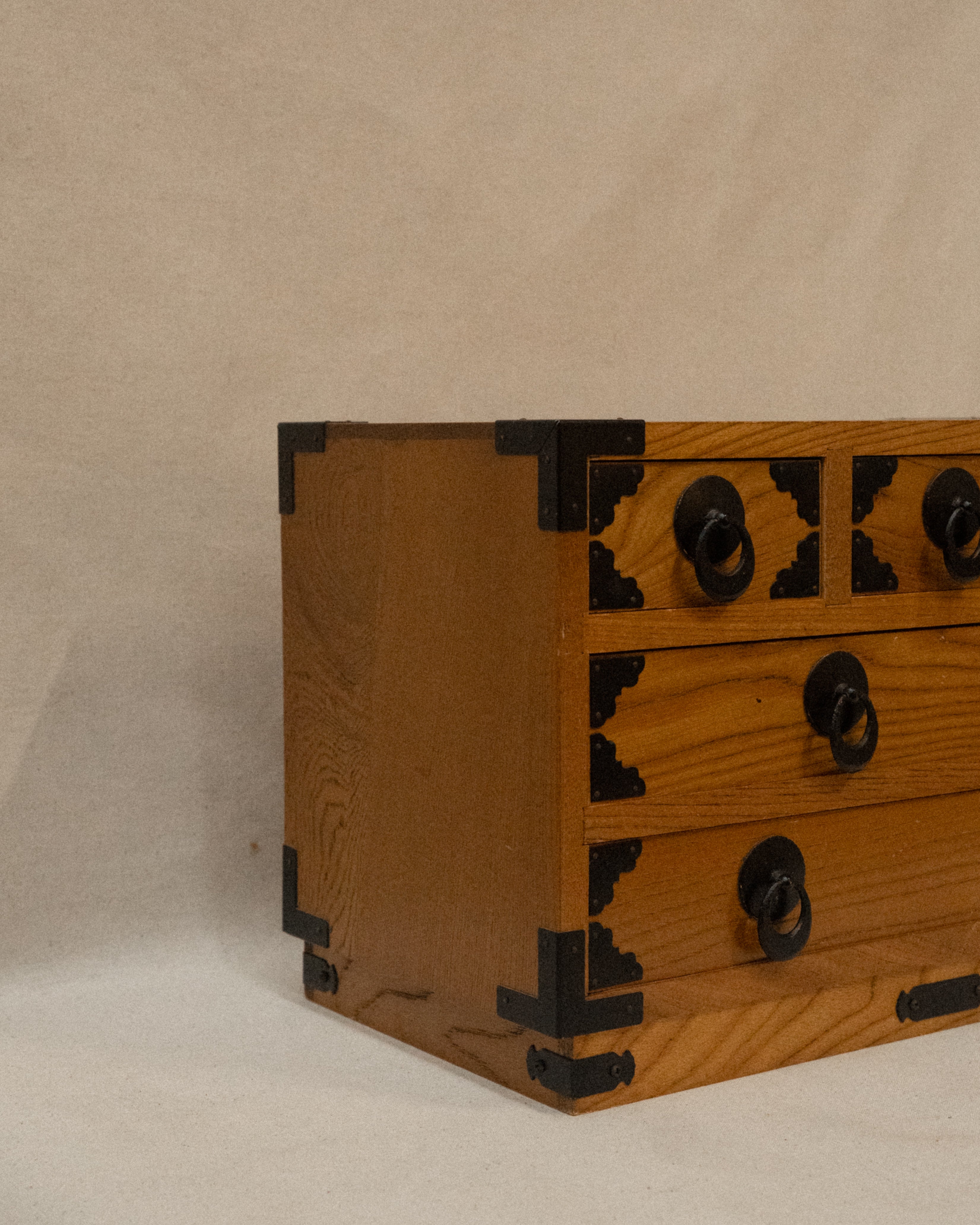 Japanese wooden chest of drawers lined with yellow fabric