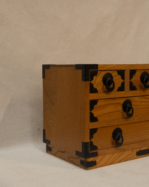Japanese wooden chest of drawers lined with yellow fabric