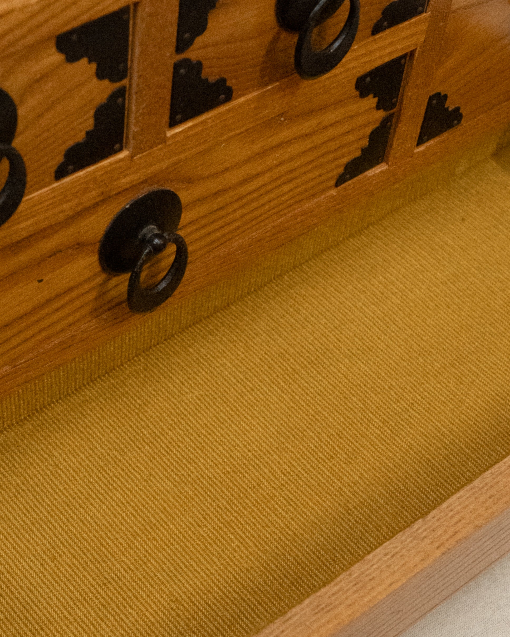 Japanese wooden chest of drawers lined with yellow fabric