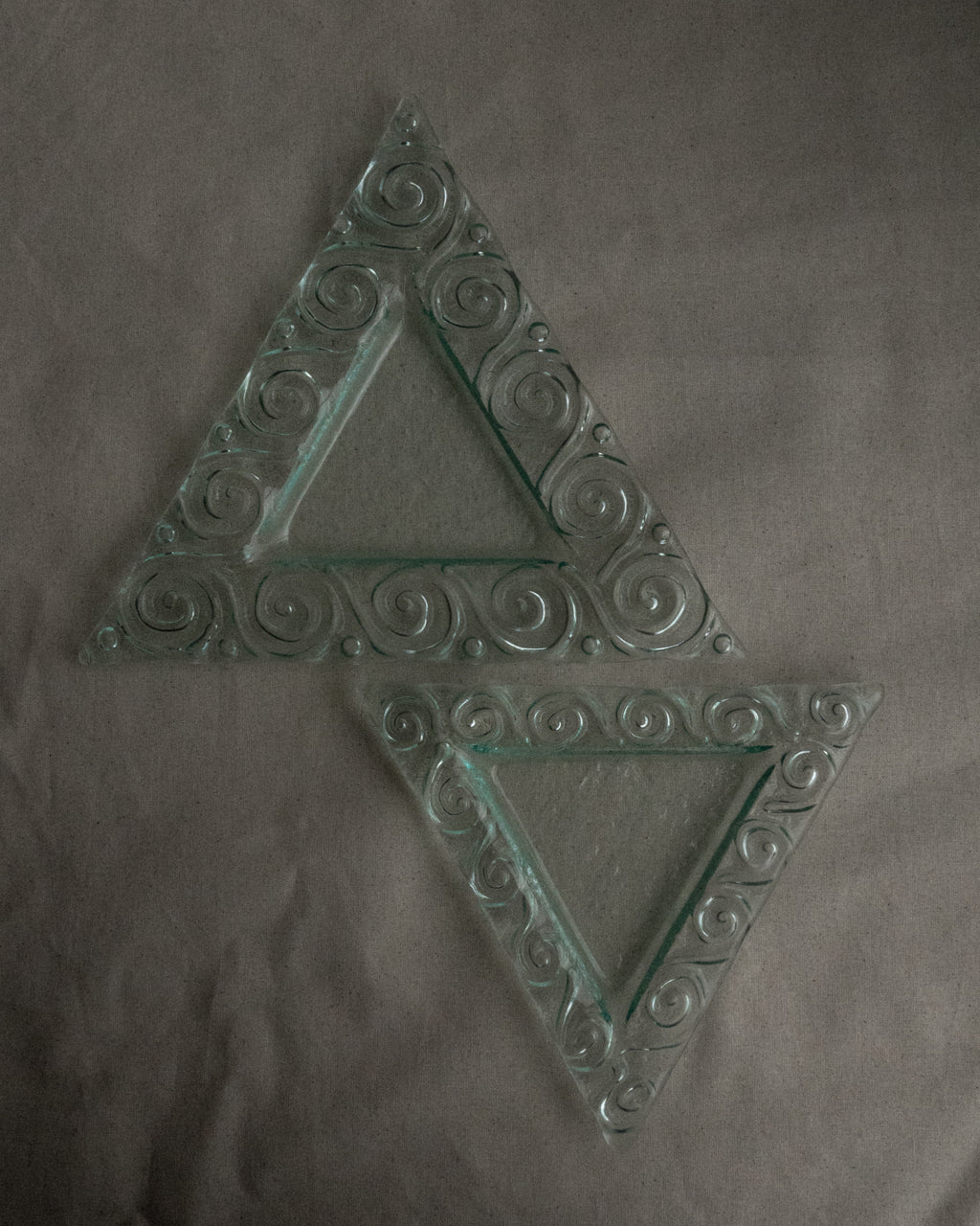 Pair of stackable triangle glass trays with spiral edges