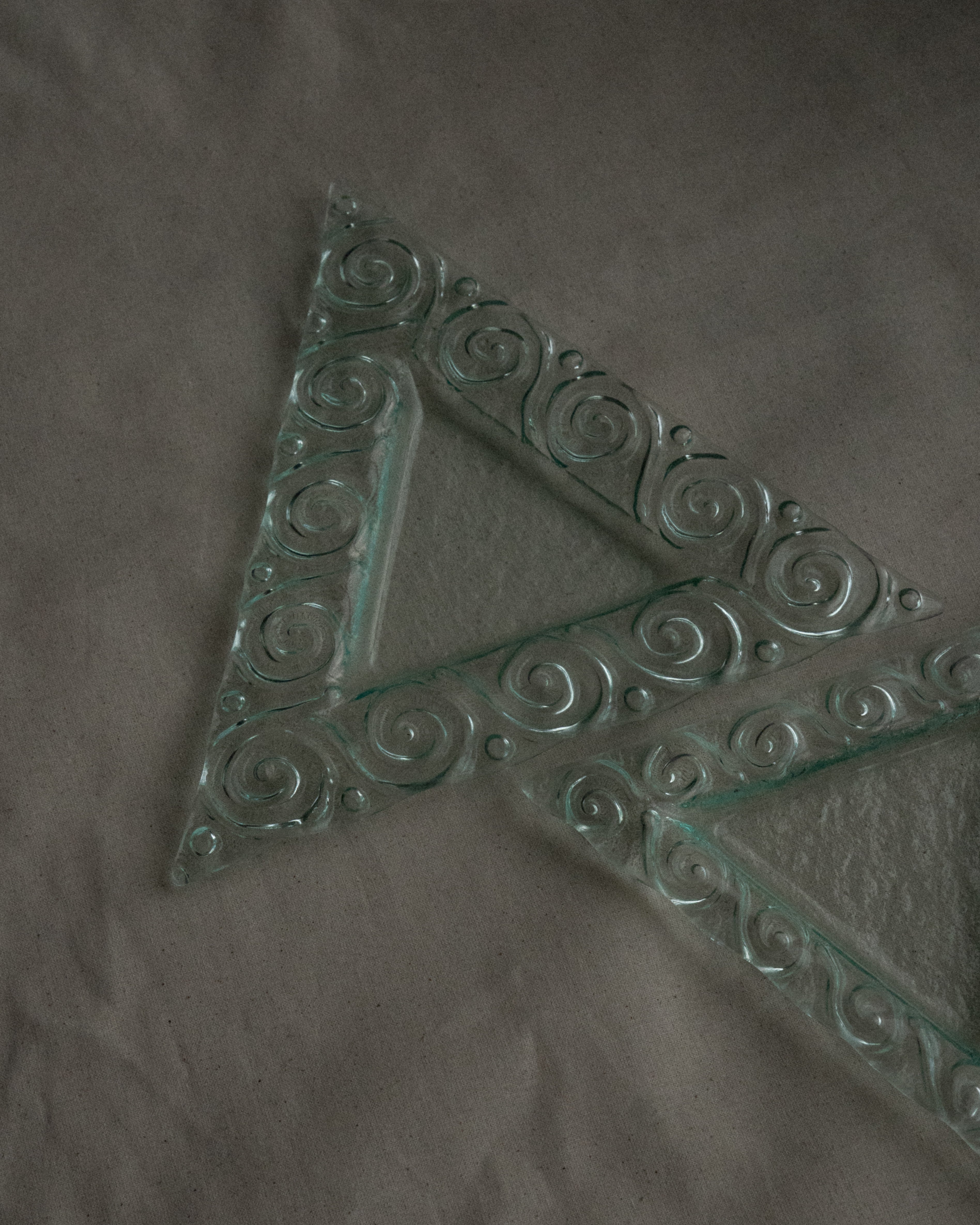 Pair of stackable triangle glass trays with spiral edges