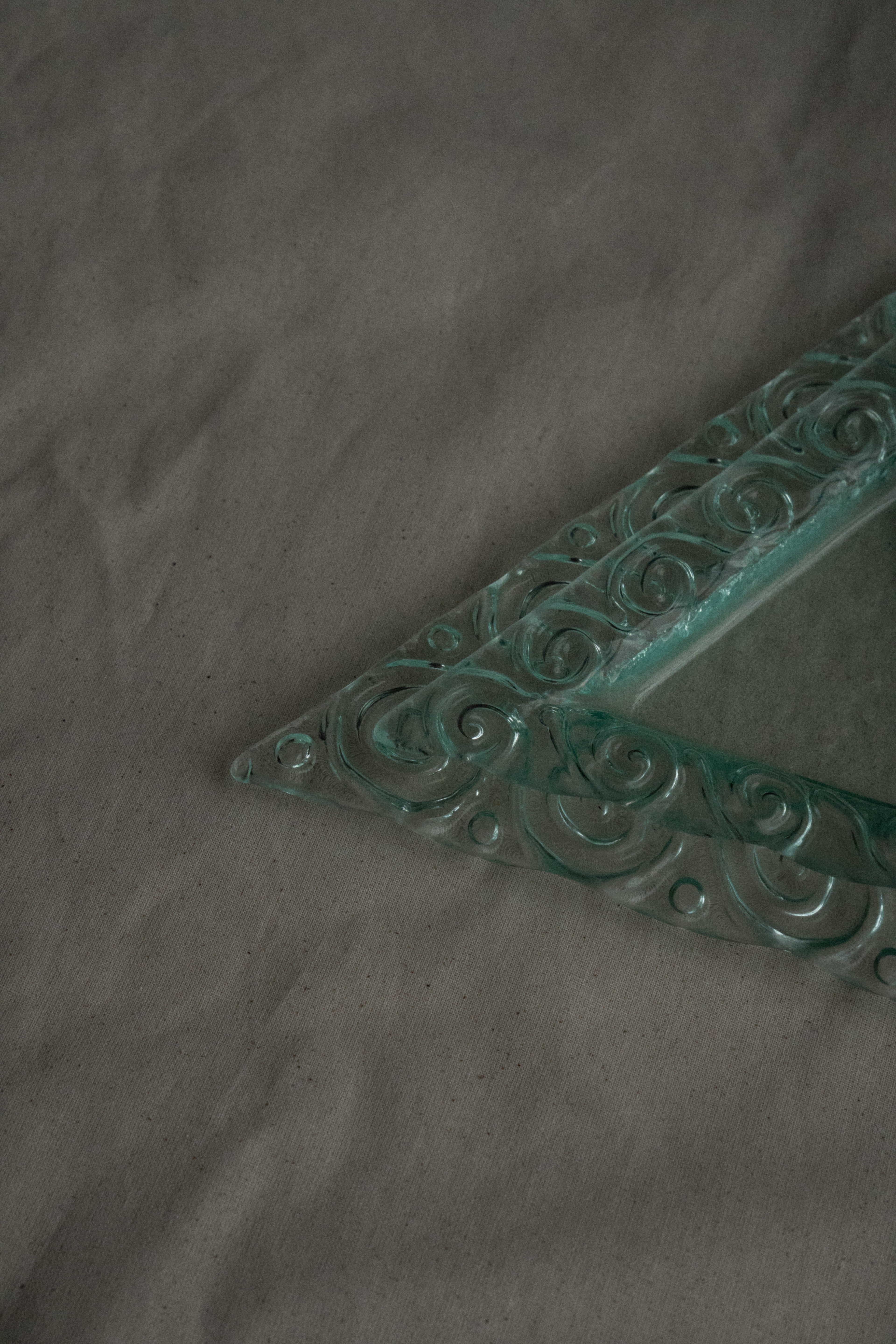 Pair of stackable triangle glass trays with spiral edges