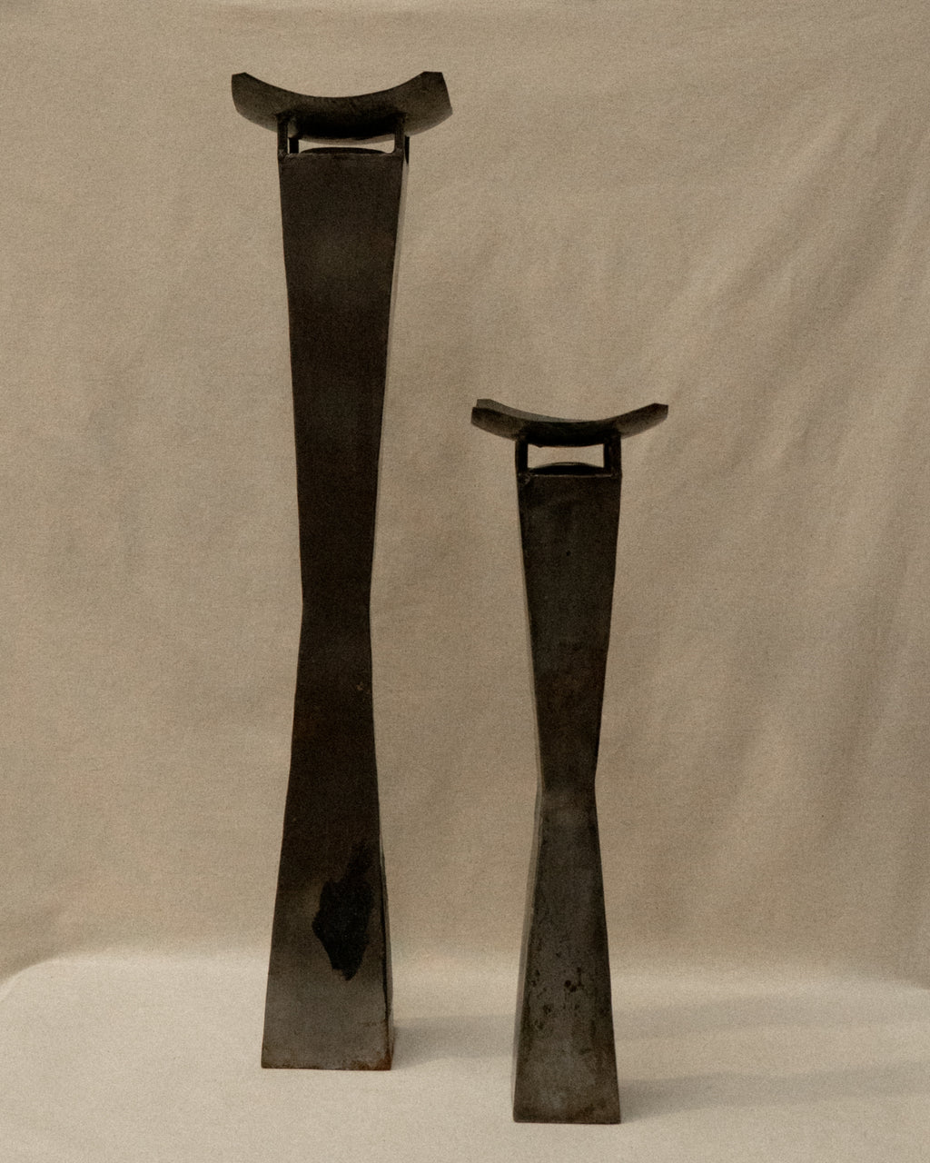 Pair of brutalist metal candle holder pedestals