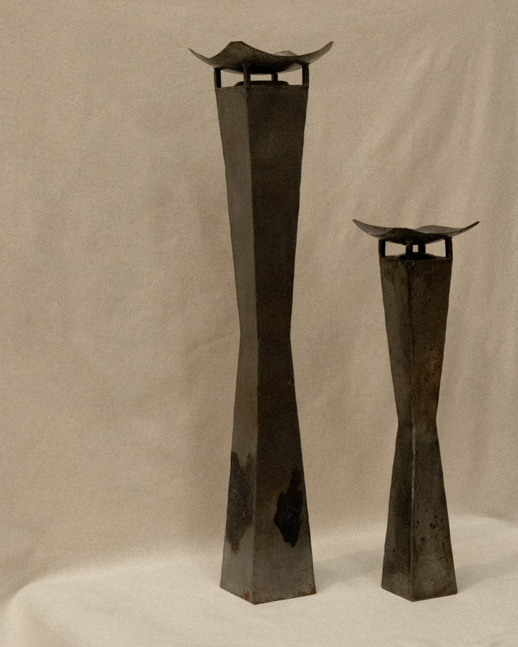 Pair of brutalist metal candle holder pedestals