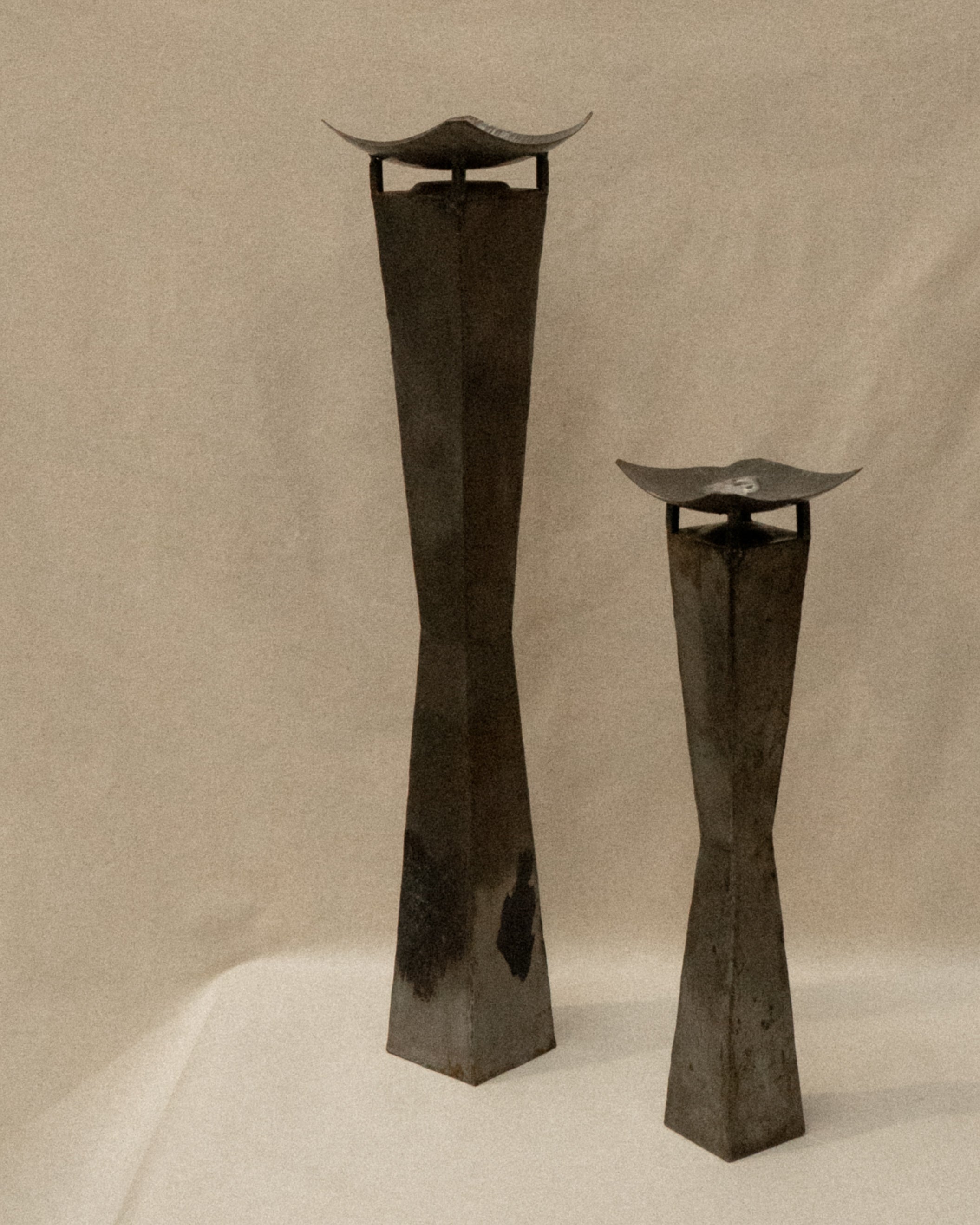 Pair of brutalist metal candle holder pedestals