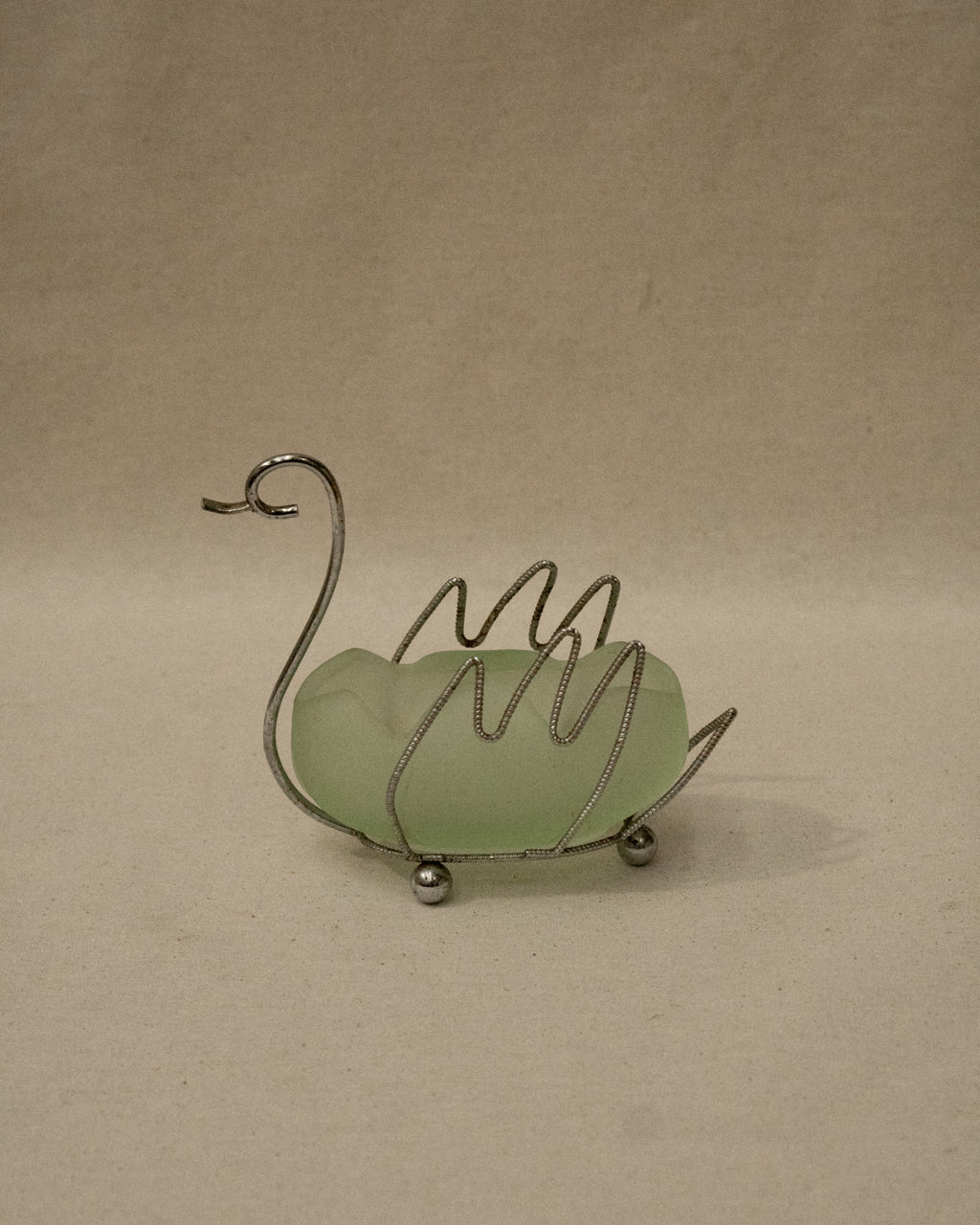 Metal swan with green glass insert