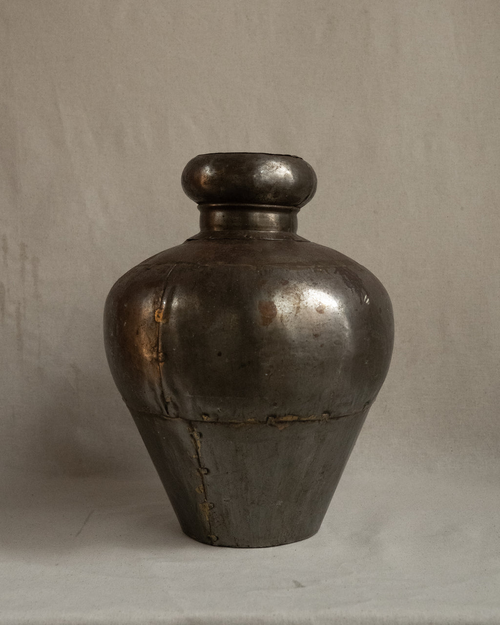 Indian water vessel with silvery tone and brass solder