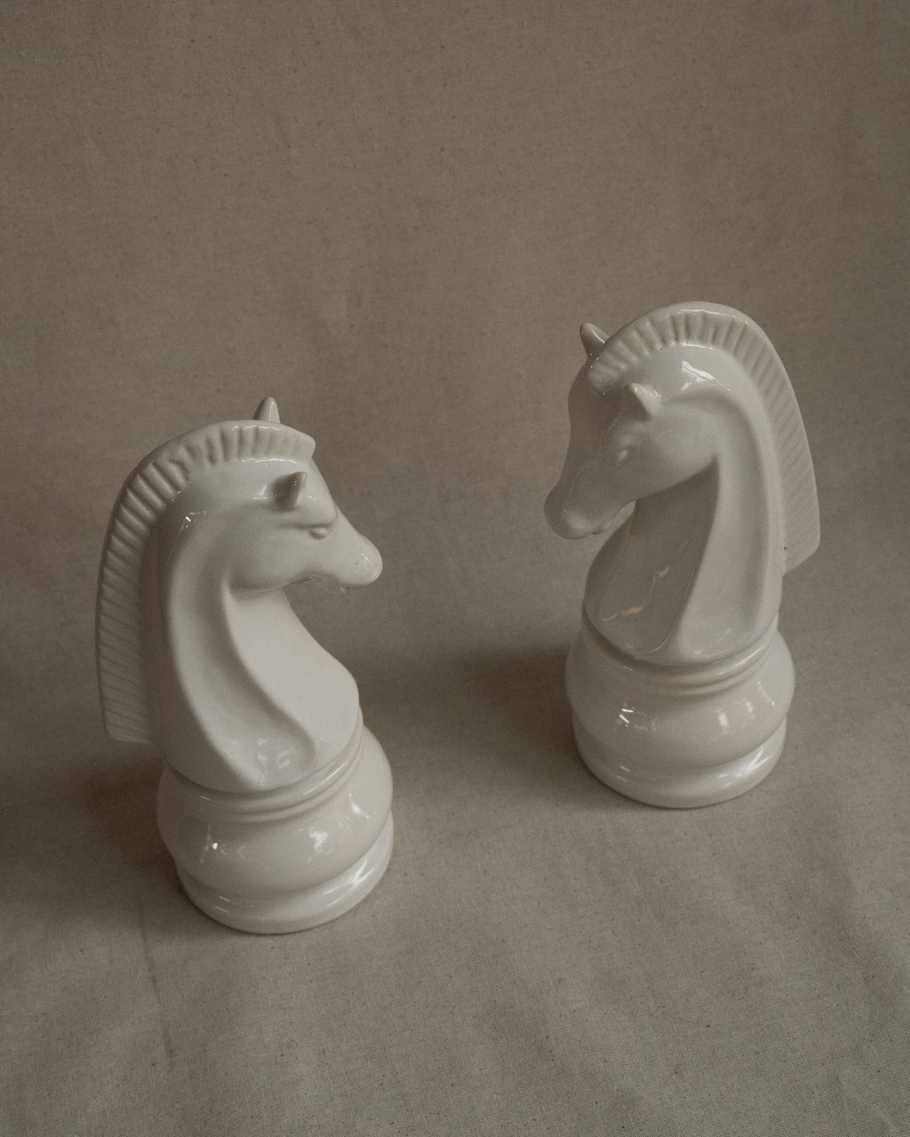 Pair of white ceramic knight chess pieces