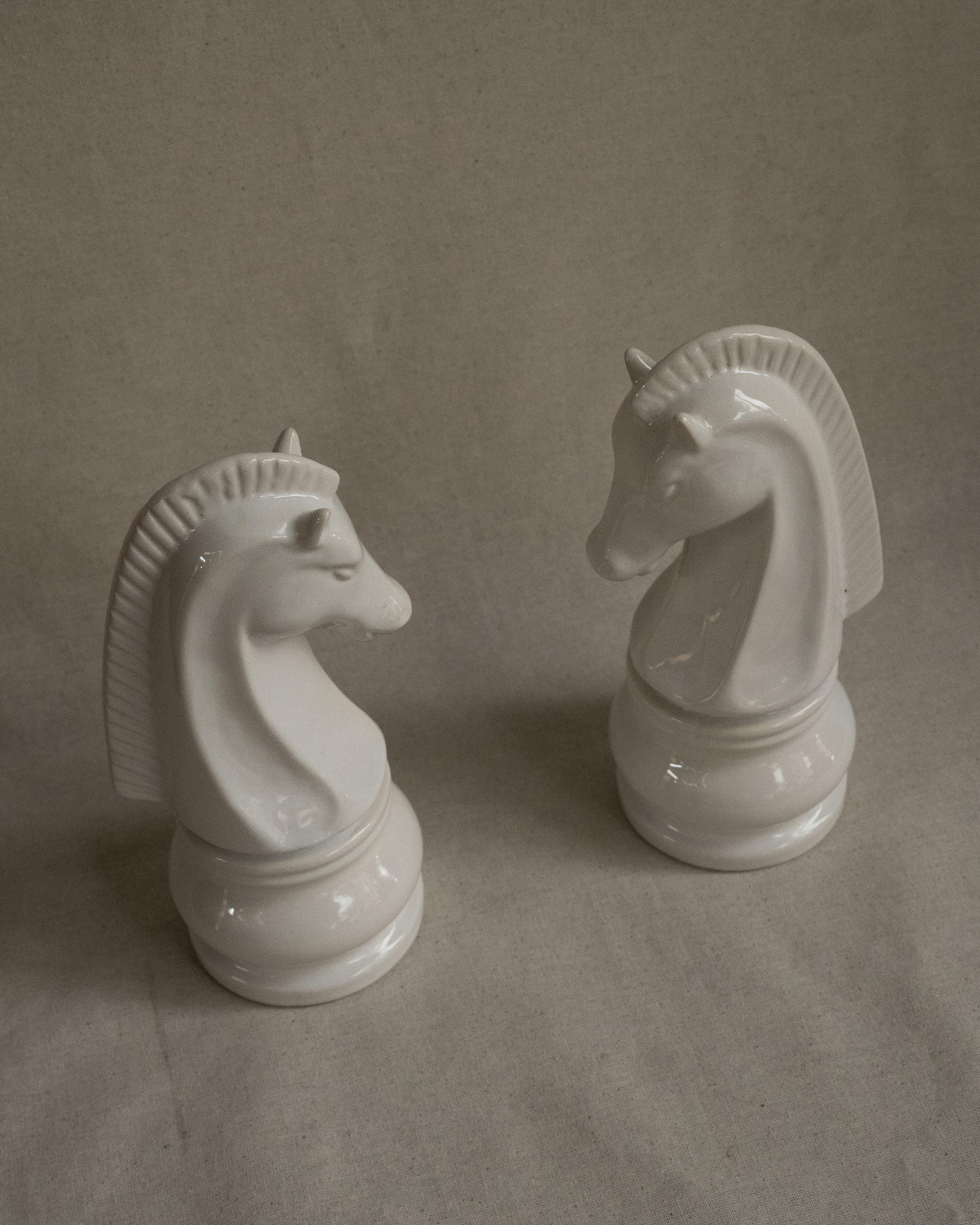 Pair of white ceramic knight chess pieces