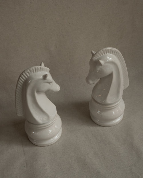 Pair of white ceramic knight chess pieces