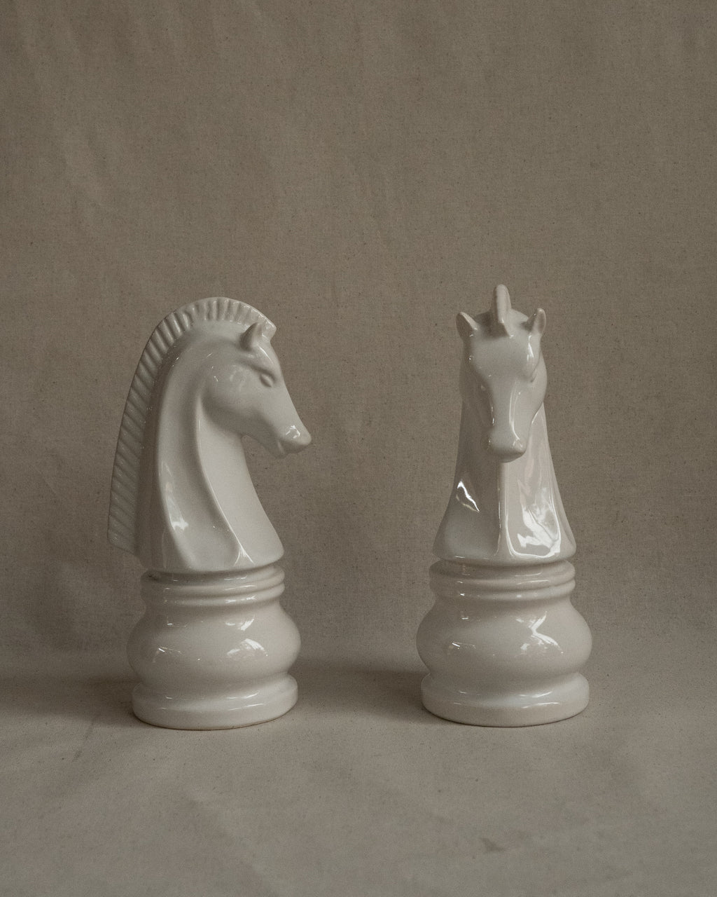 Pair of white ceramic knight chess pieces