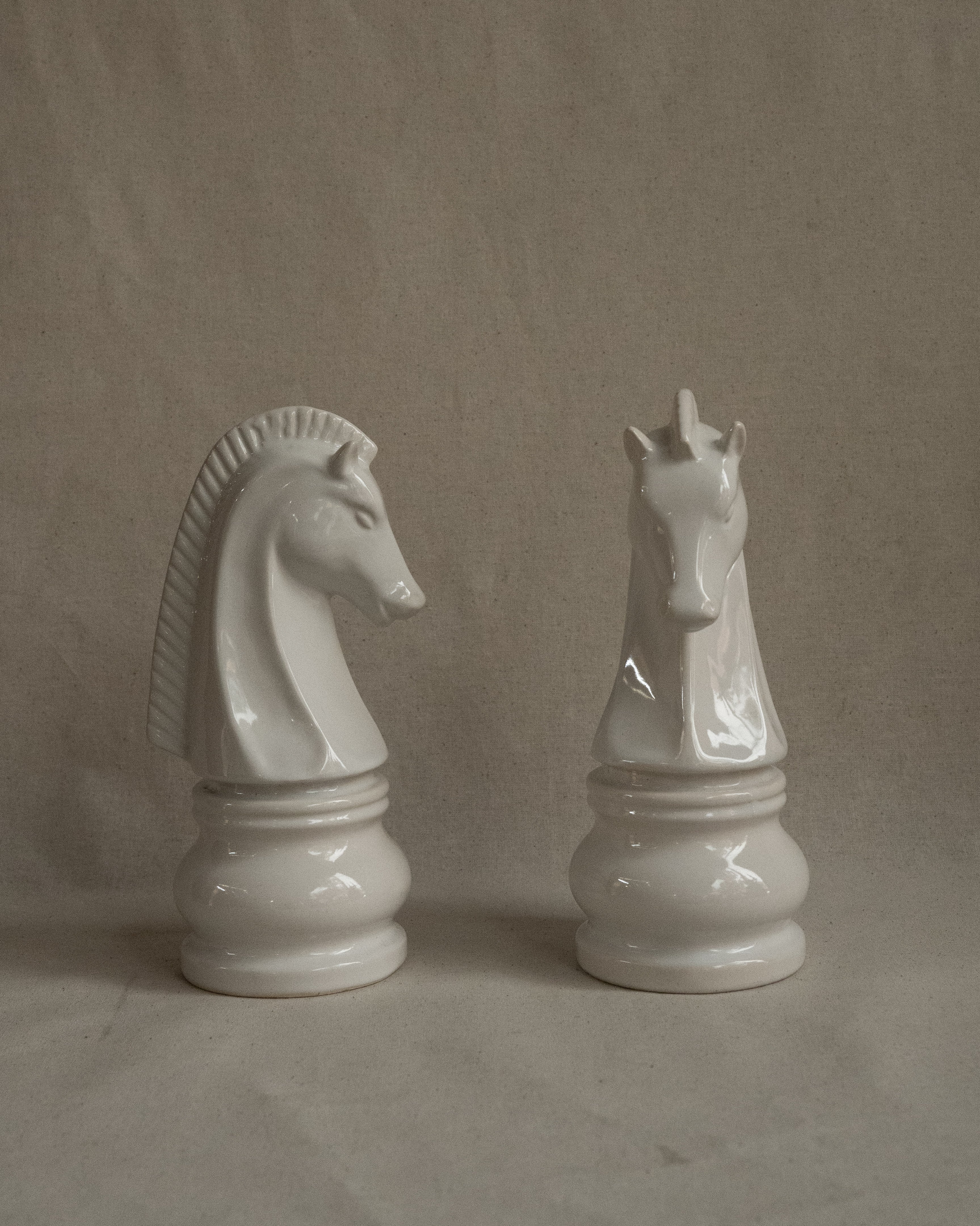 Pair of white ceramic knight chess pieces