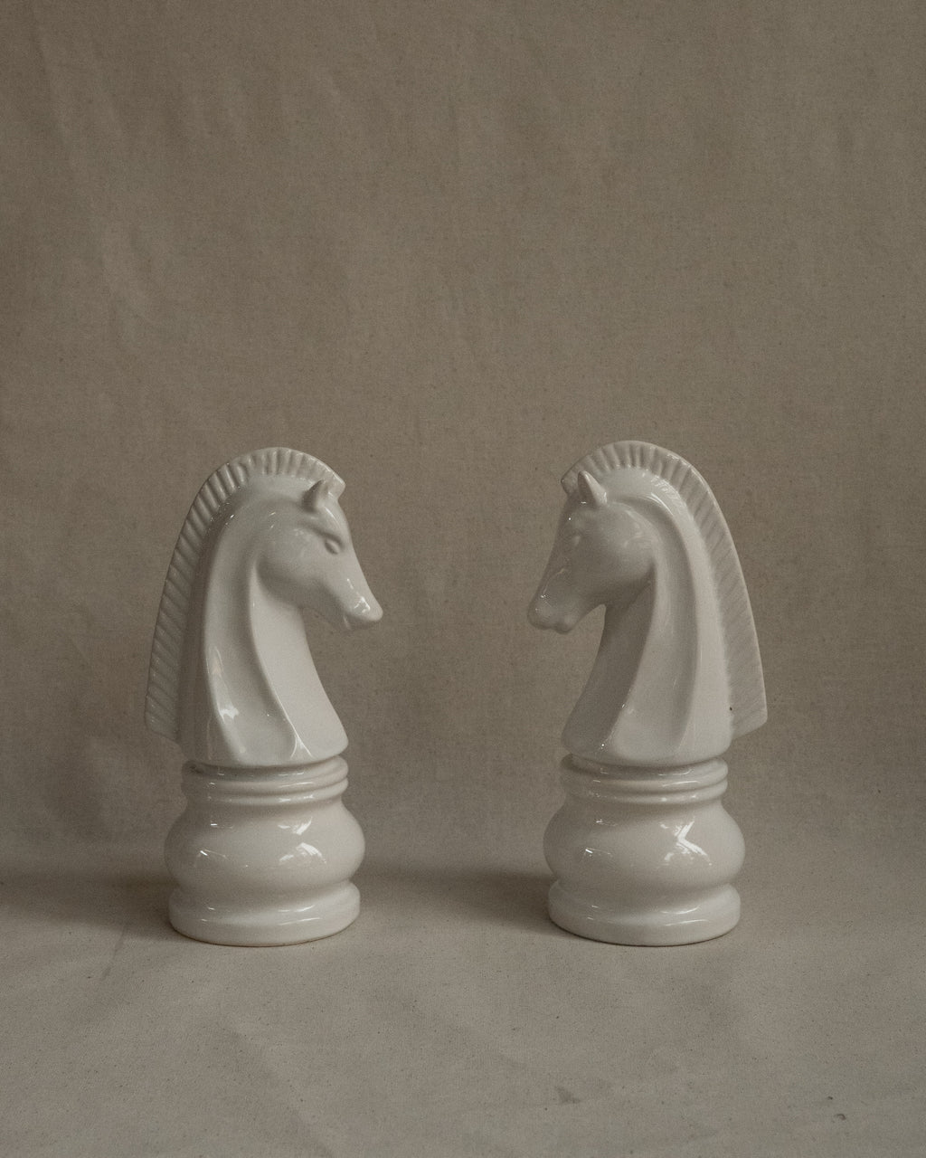 Pair of white ceramic knight chess pieces