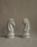 Pair of white ceramic knight chess pieces