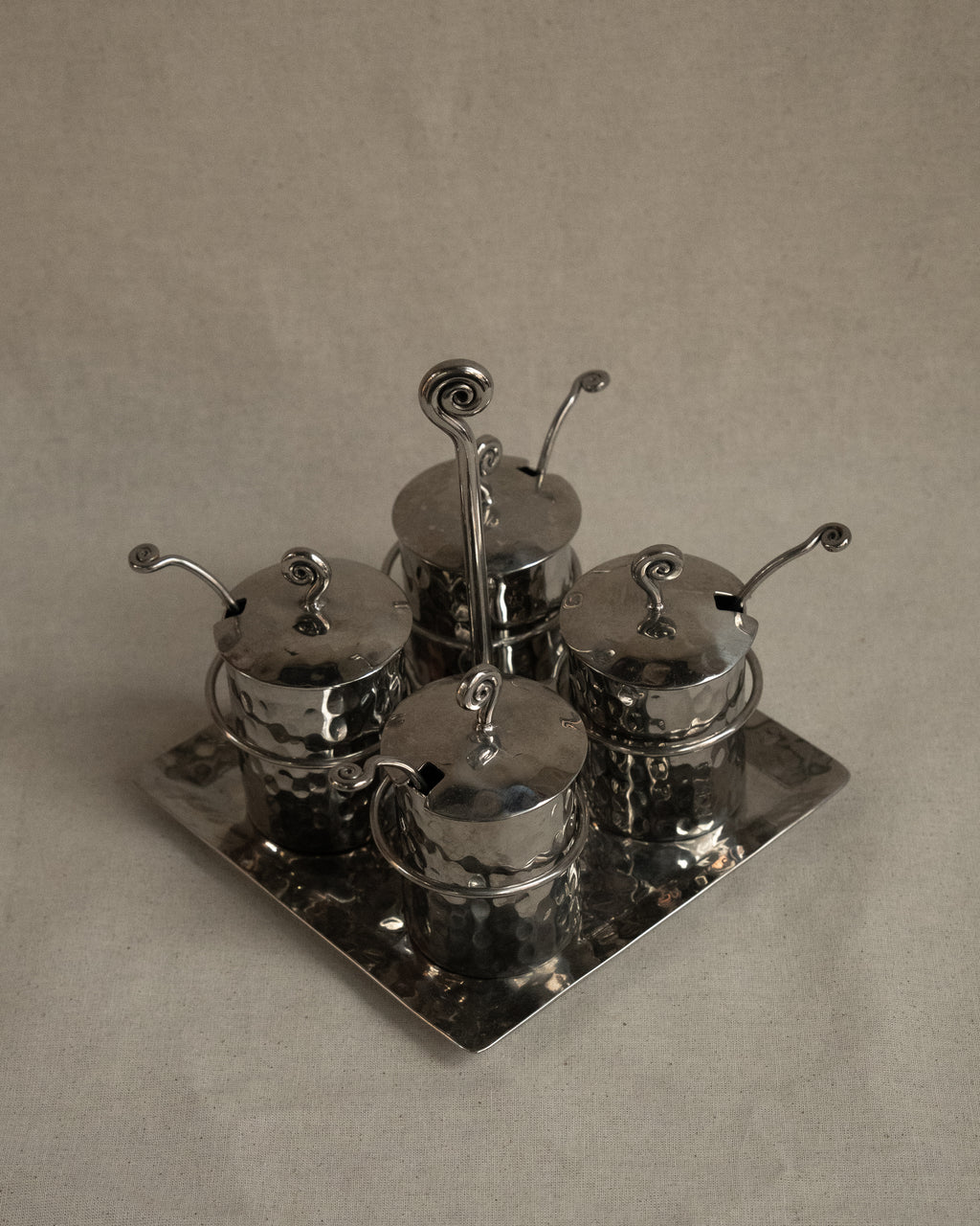 Silver toned metal condiment tray with glass inserts and spoons