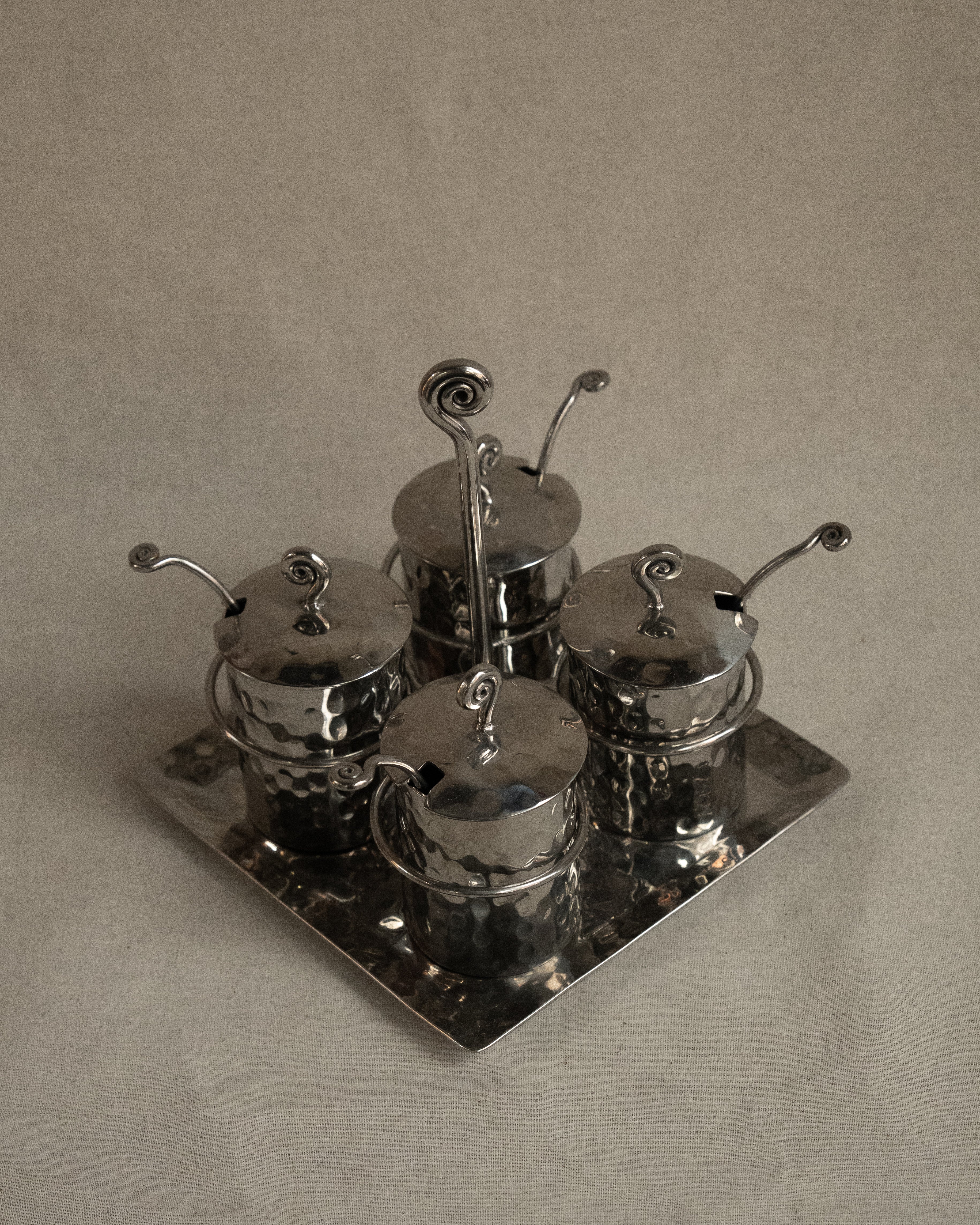 Silver toned metal condiment tray with glass inserts and spoons
