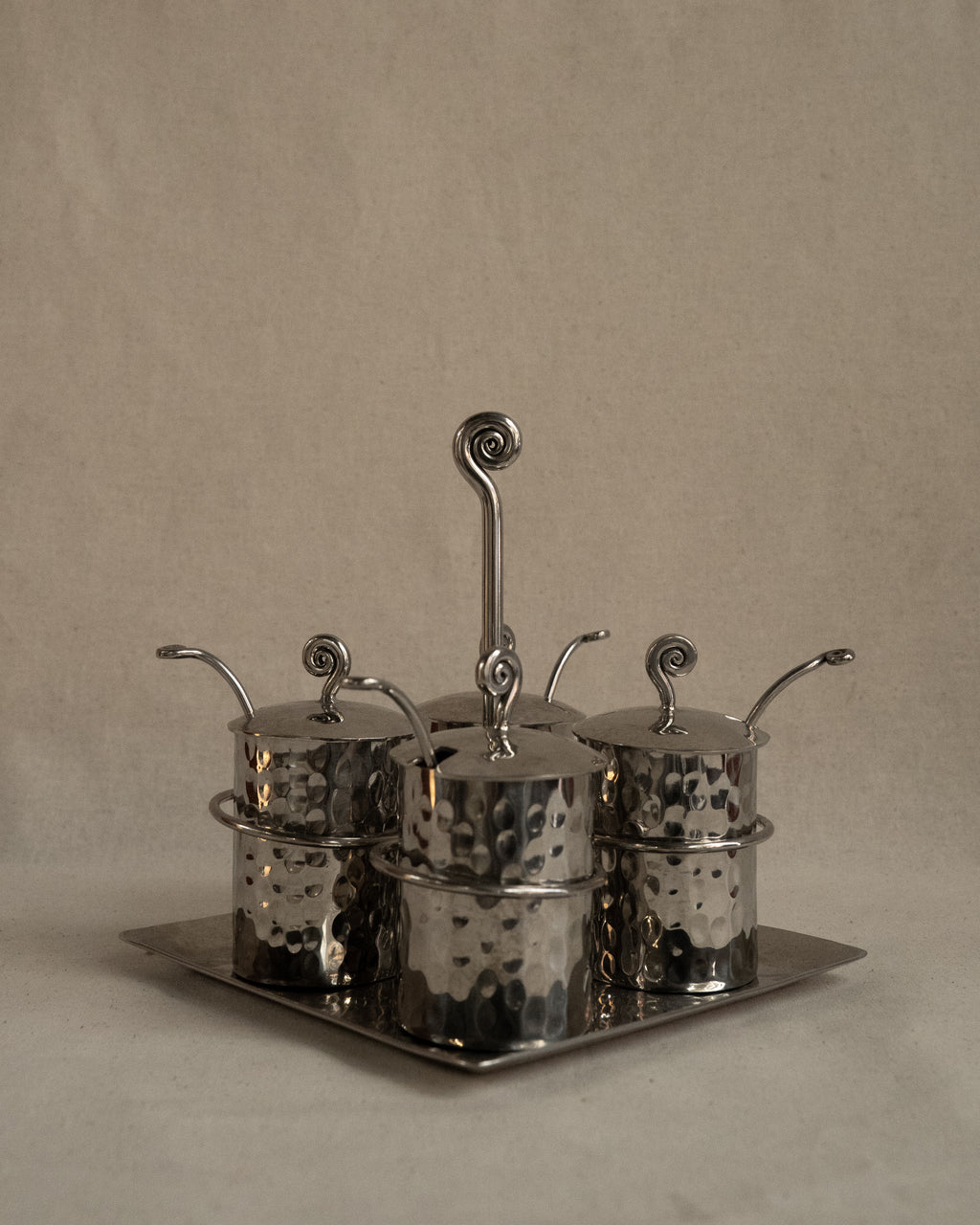 Silver toned metal condiment tray with glass inserts and spoons