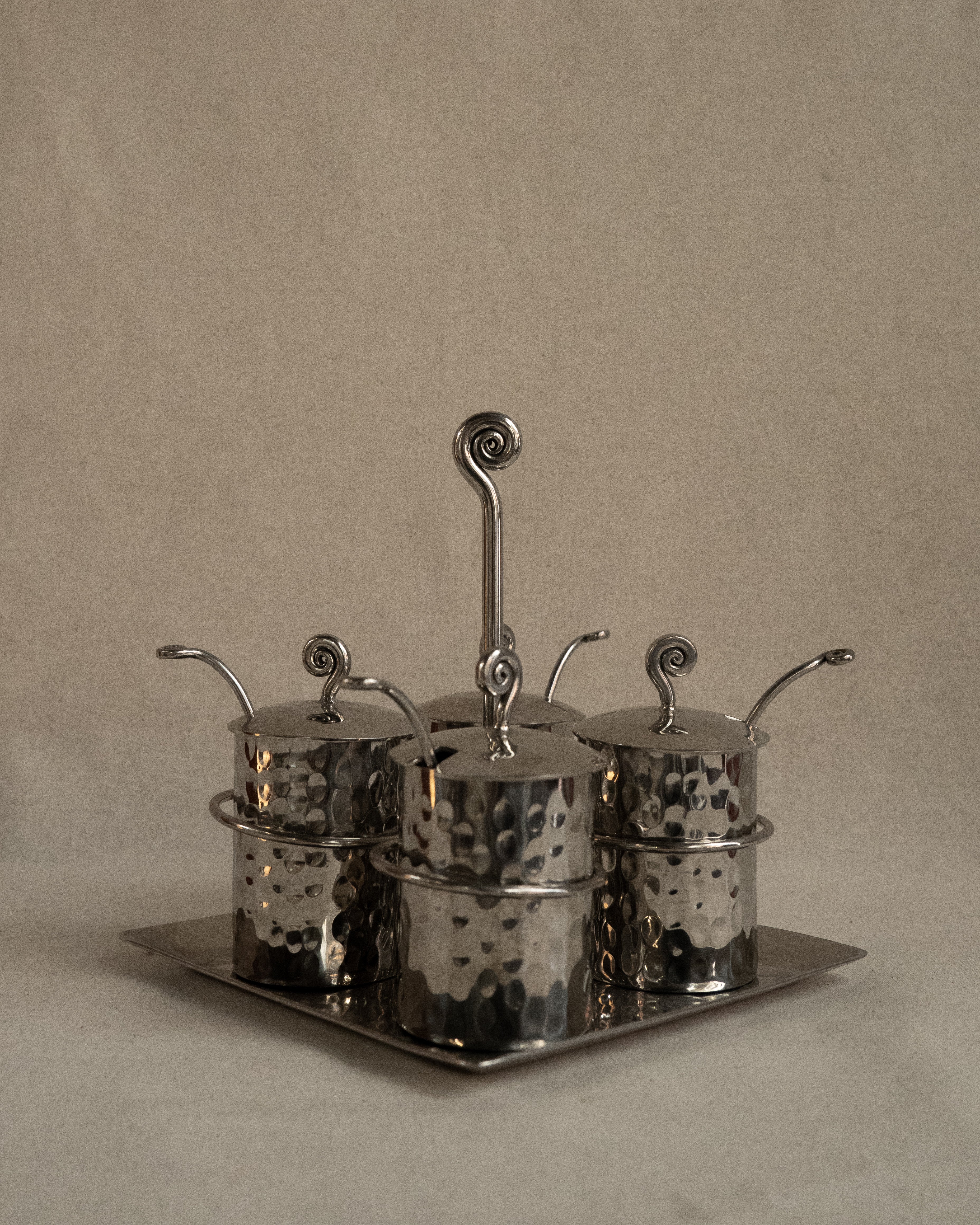 Silver toned metal condiment tray with glass inserts and spoons