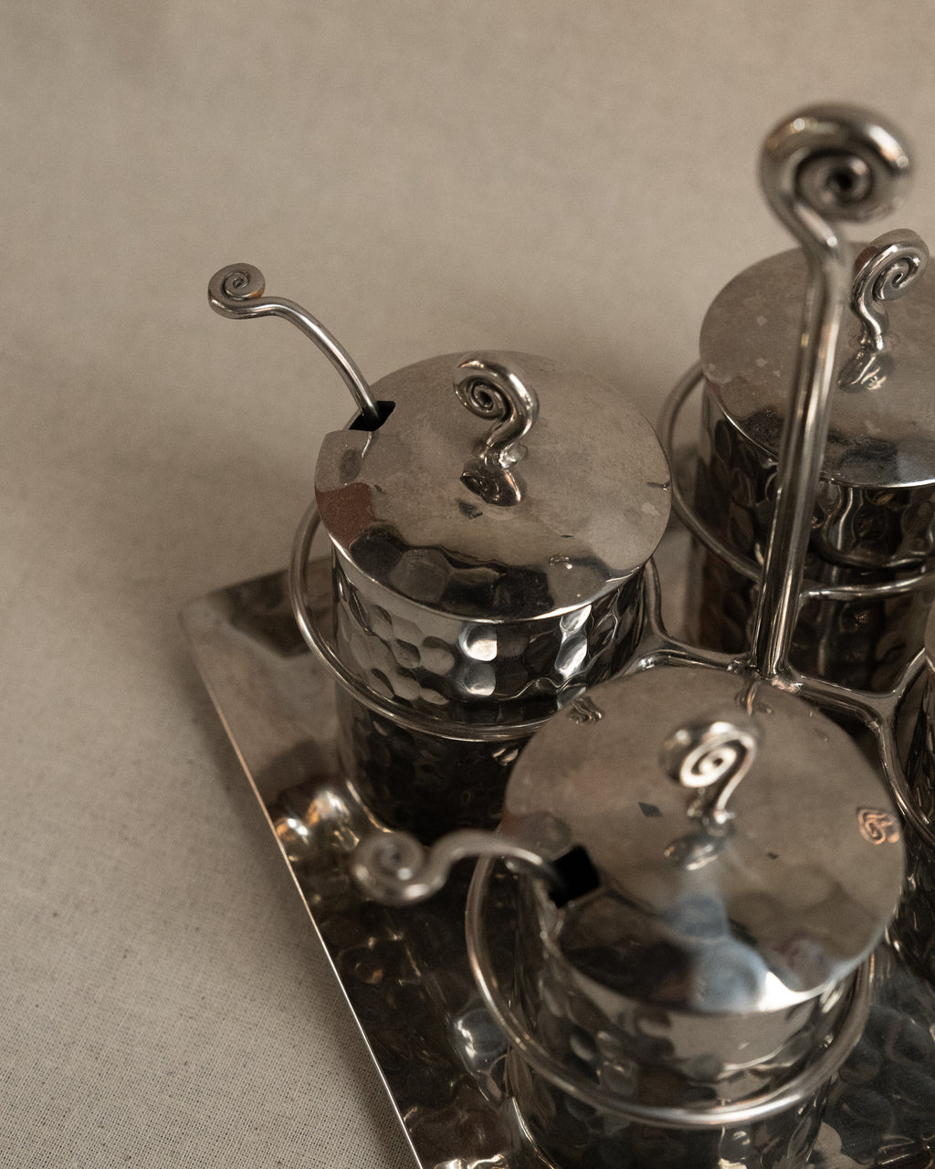 Silver toned metal condiment tray with glass inserts and spoons