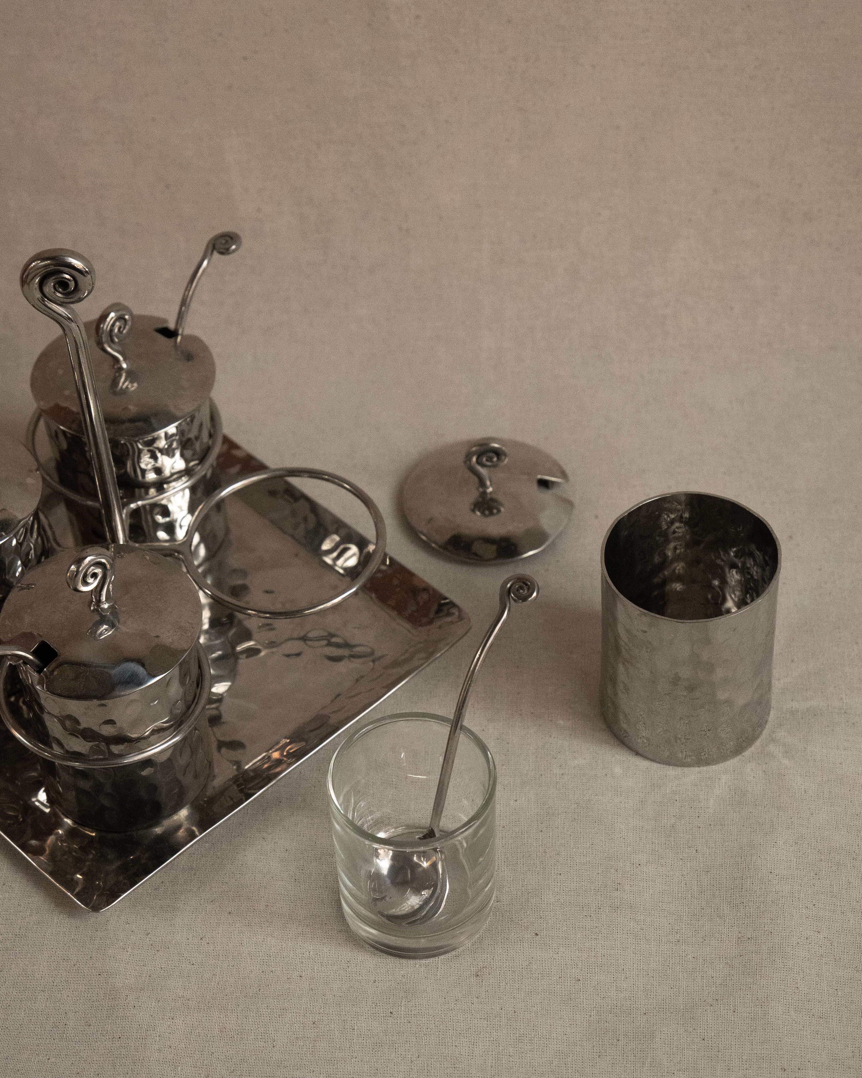 Silver toned metal condiment tray with glass inserts and spoons