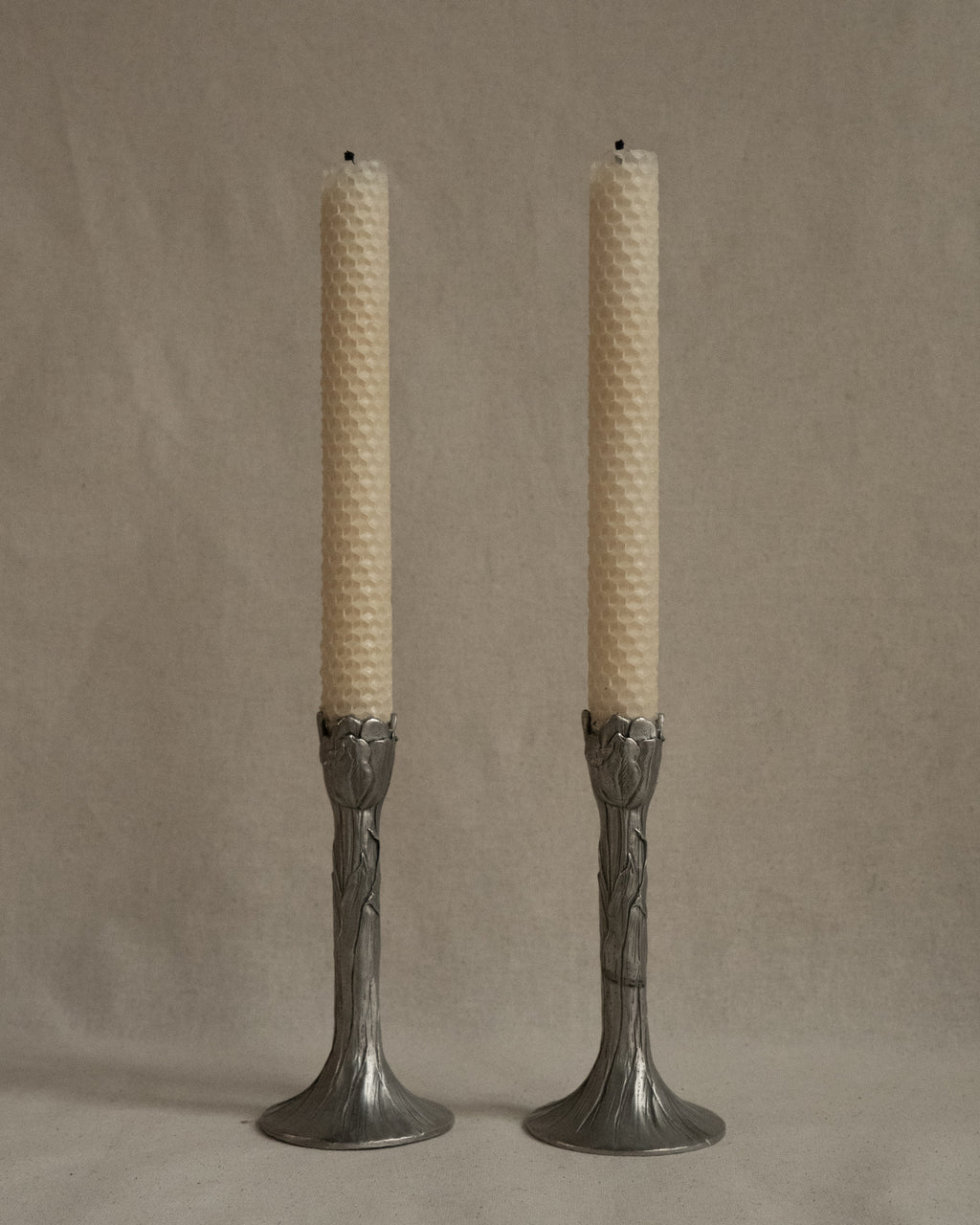 Pair of tulip pewter candle holders