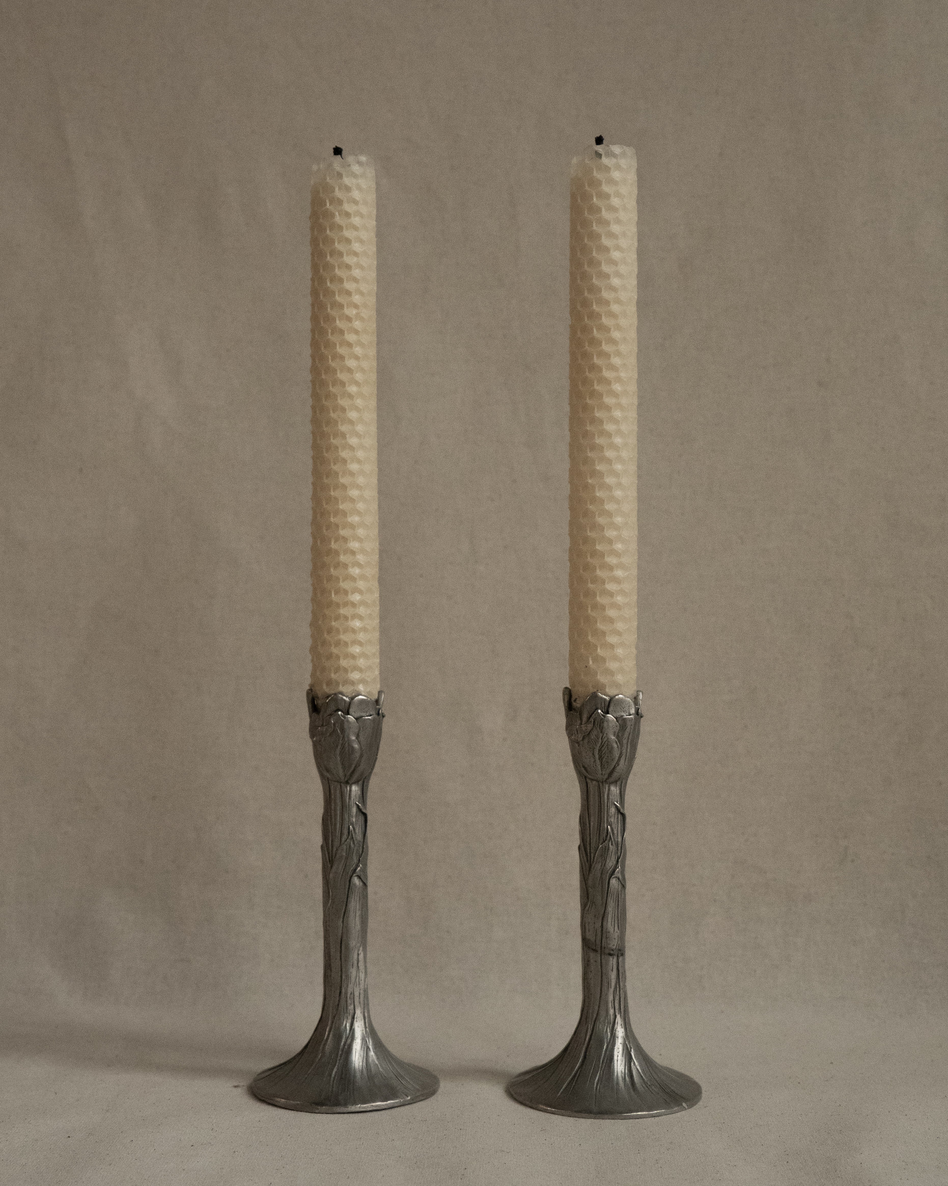Pair of tulip pewter candle holders