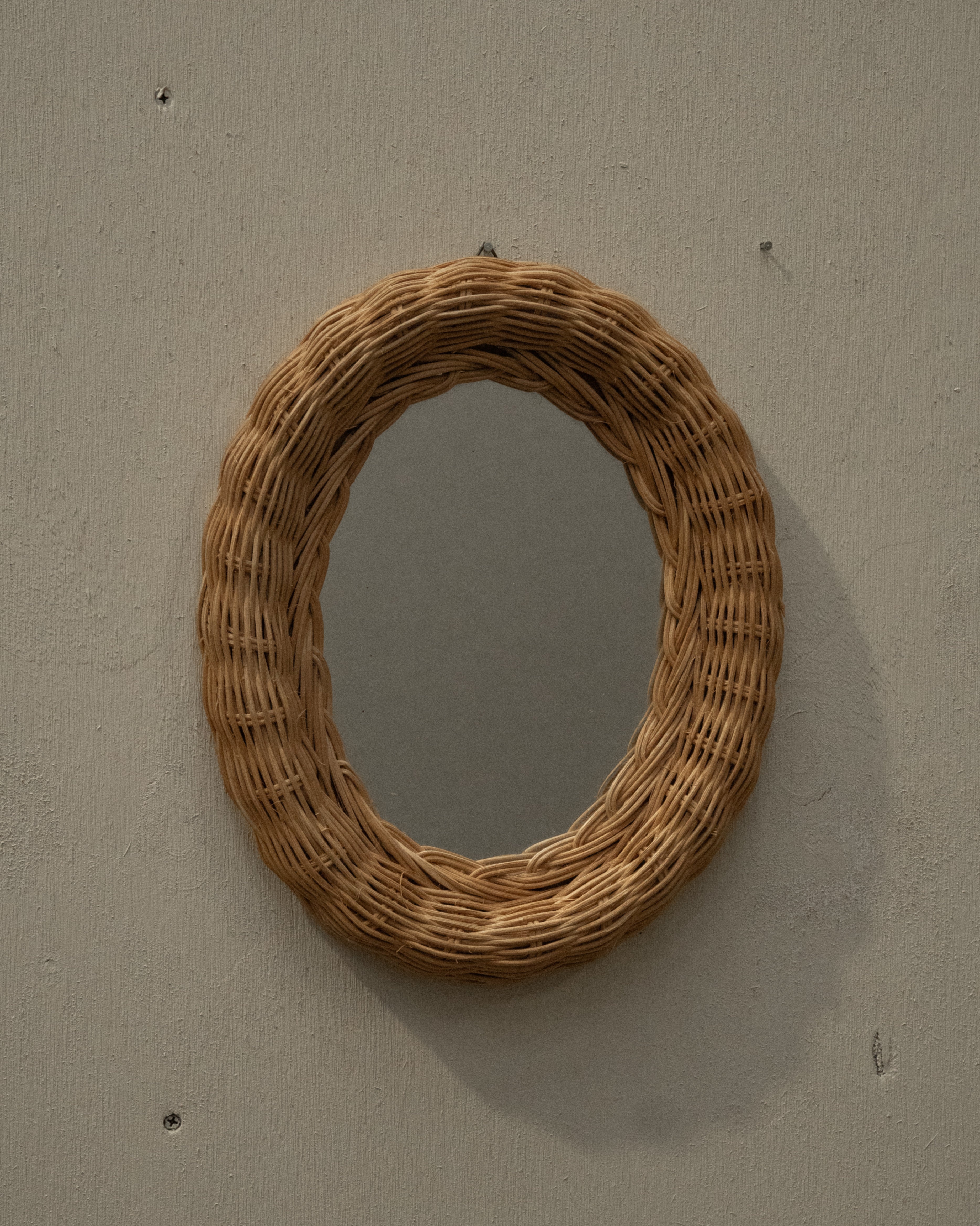 Woven rattan wall mirror