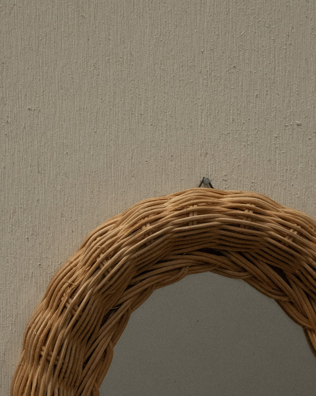 Woven rattan wall mirror