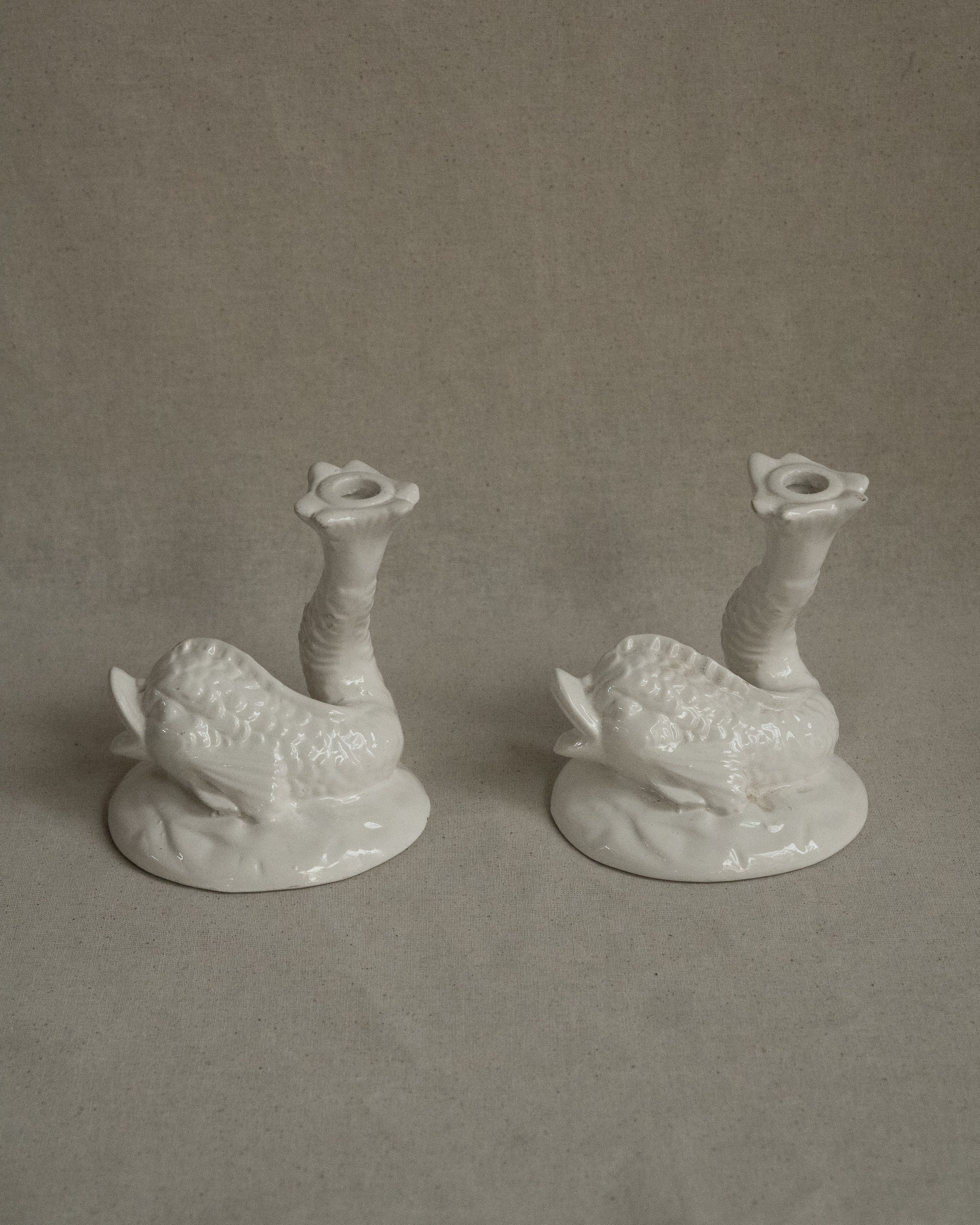 Pair of white ceramic fish candle holders