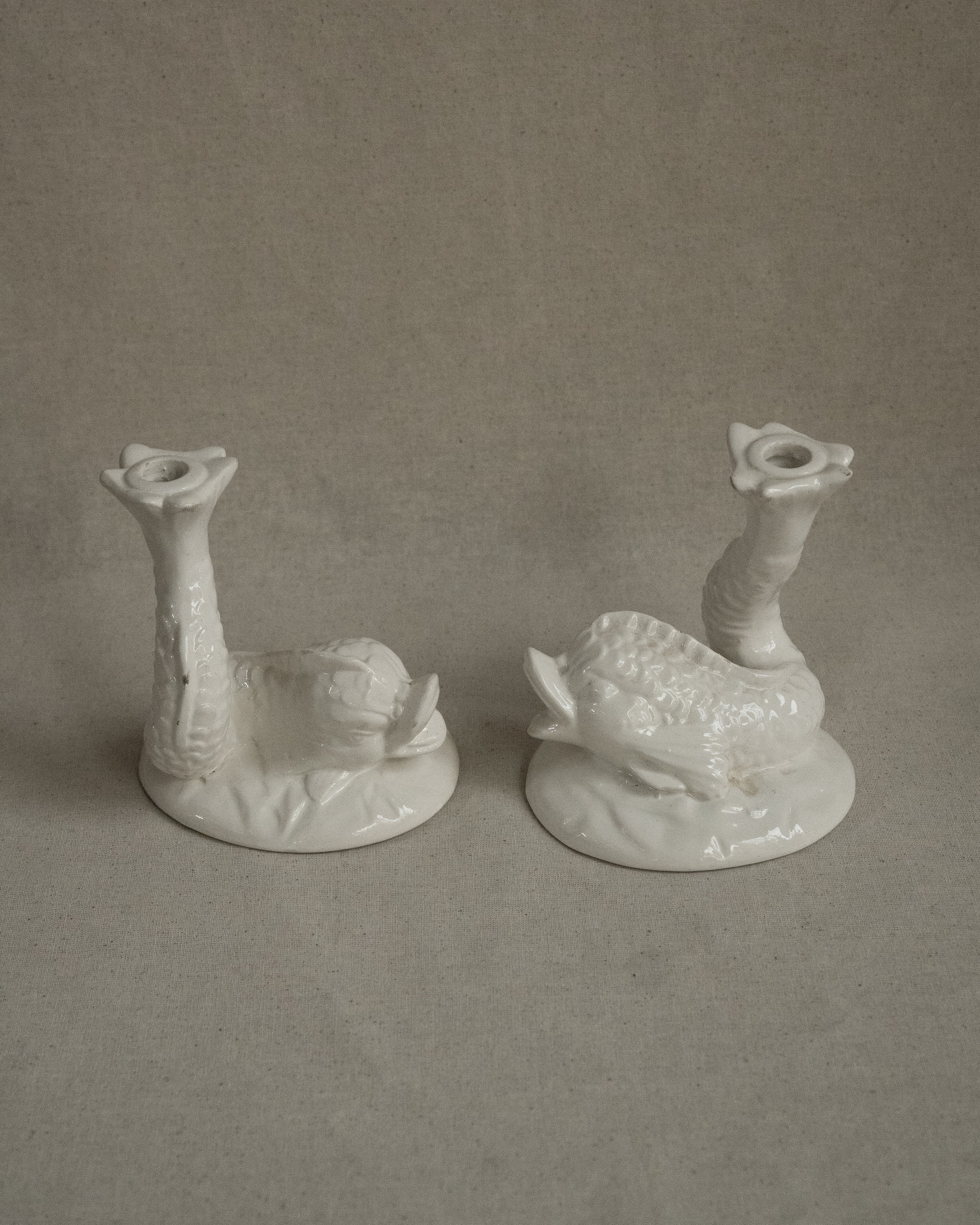 Pair of white ceramic fish candle holders