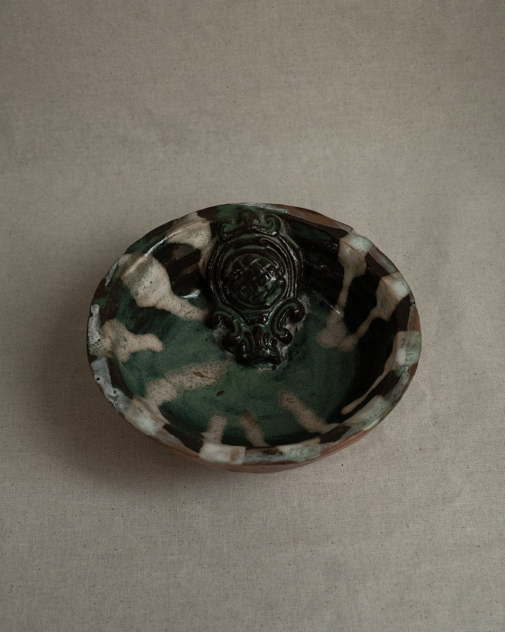 Ceramic bowl with green blue white brown hues