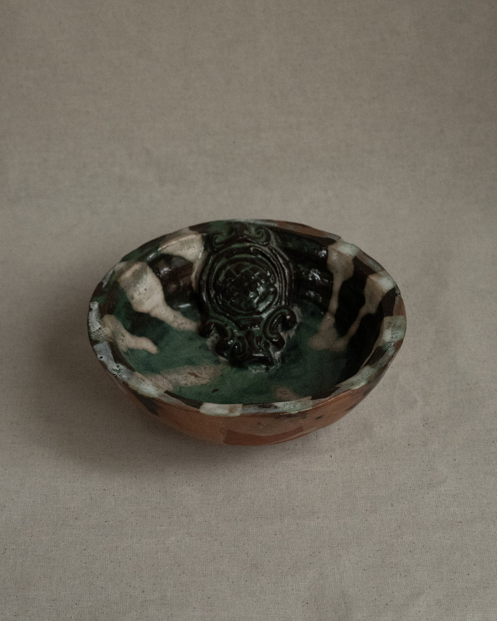 Ceramic bowl with green blue white brown hues
